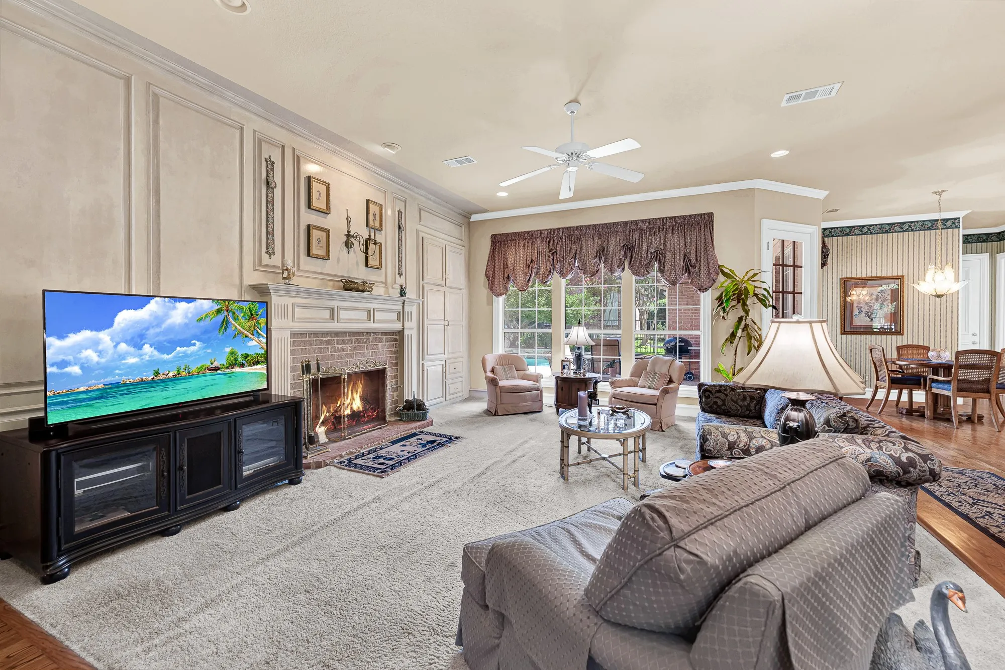 A sprawling wall of grid windows pours afternoon light across the carpeted lounge area. Enjoy a relaxing Sunday afternoon sinking into a armchair with your favorite magazine