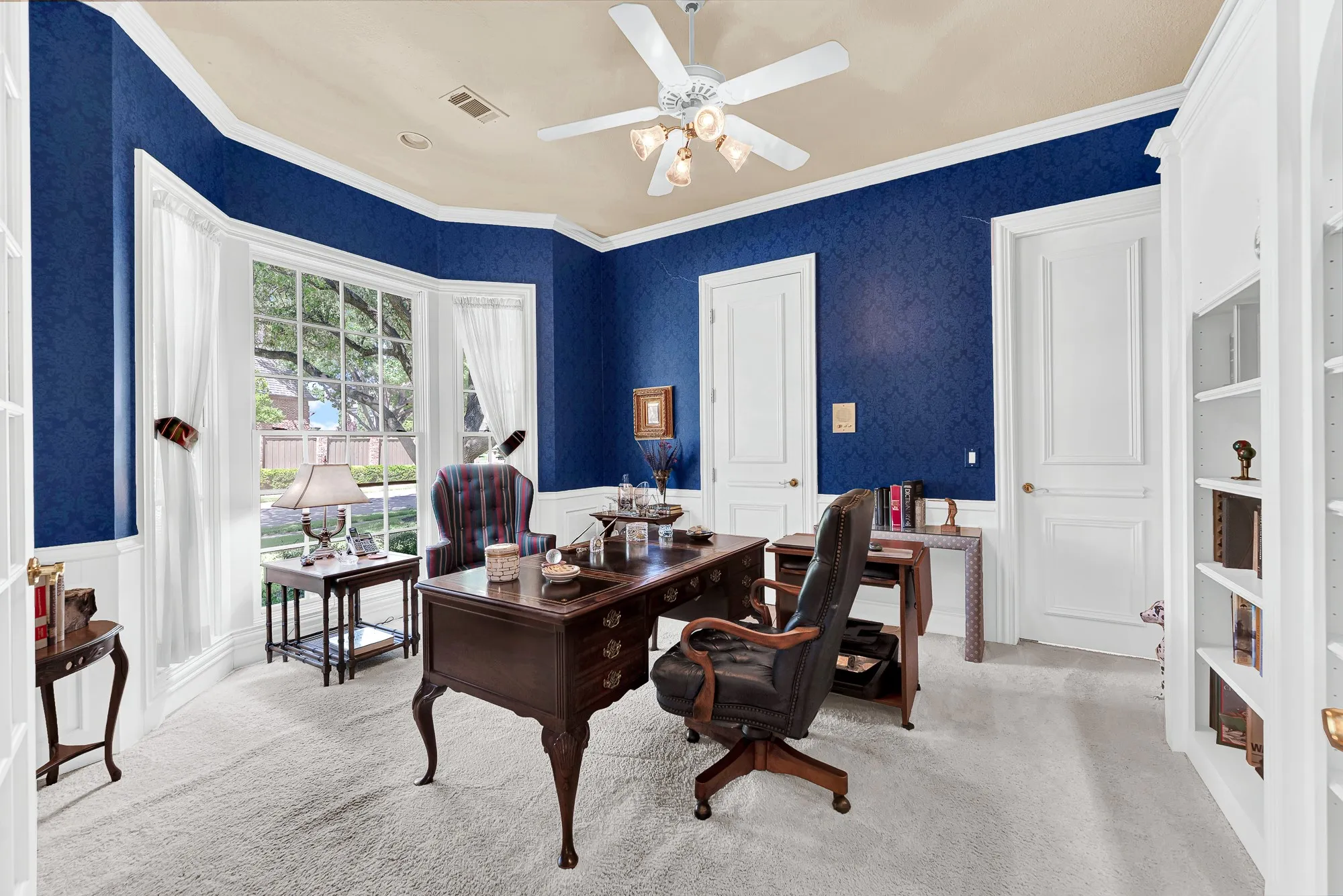 A sunlit bay window draws bright, outdoor light deep across crisp white wainscoting. Picture yourself sipping espresso while reviewing morning emails against a tranquil backyard view.