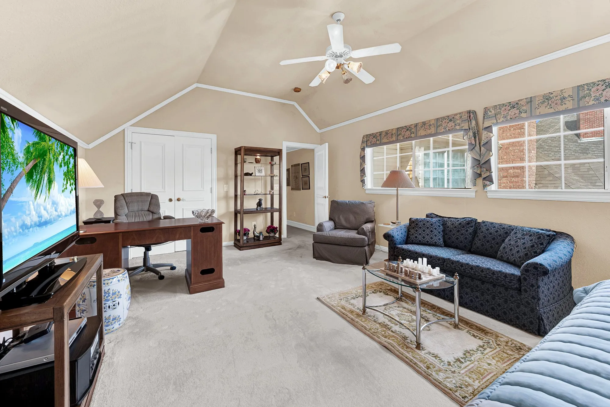 Twin dormer-style windows pull bright daytime sunshine deep into the space, emphasizing the playful intersecting angles of the overhead roofline. You can set up a dedicated homework hub or a sprawling arts and crafts zone where everyone's imagination can run wild all afternoon.