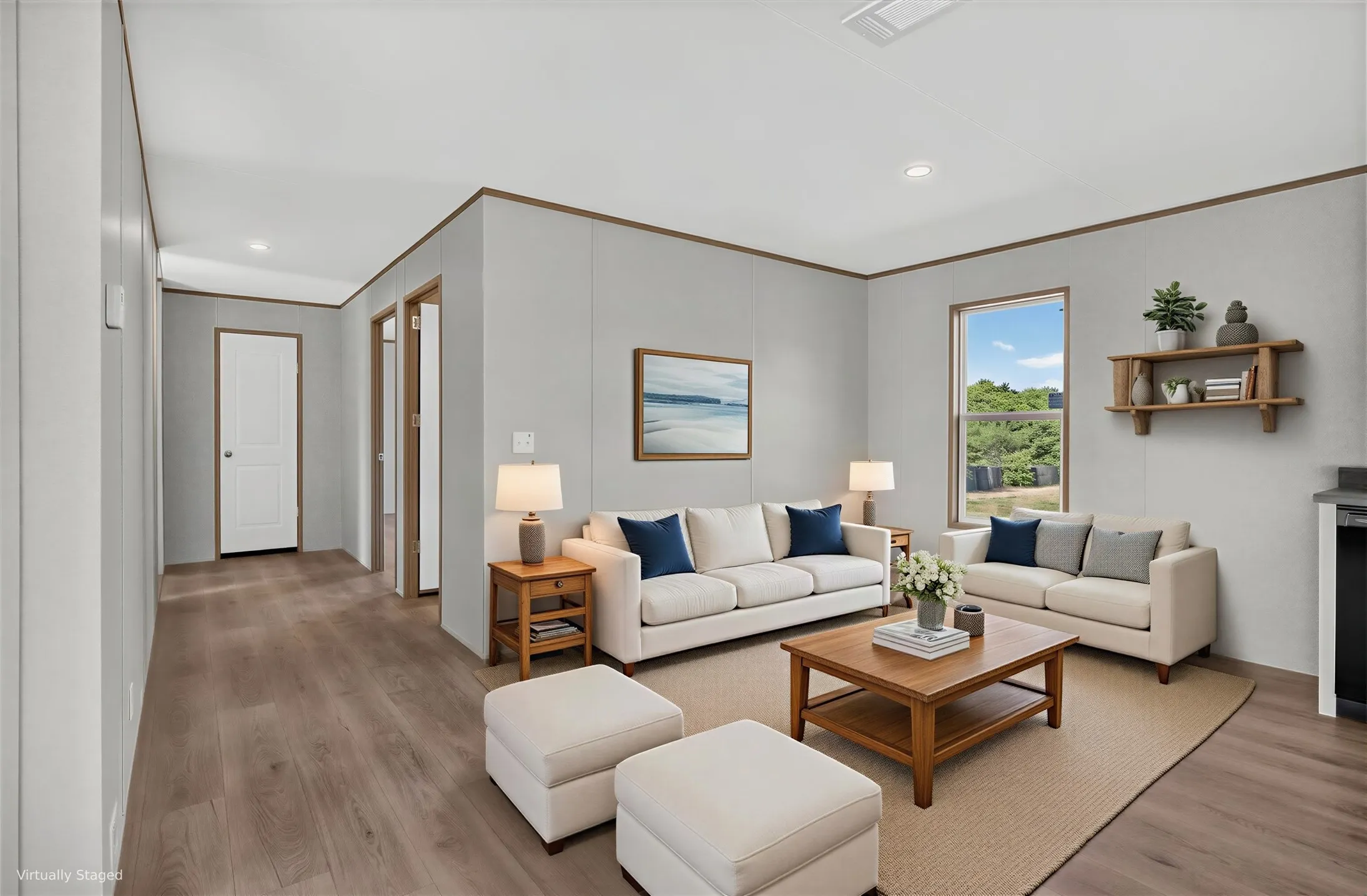 Open-concept living area featuring wood-finish flooring, recessed lighting, and a single window. Furniture is Virtually Staged