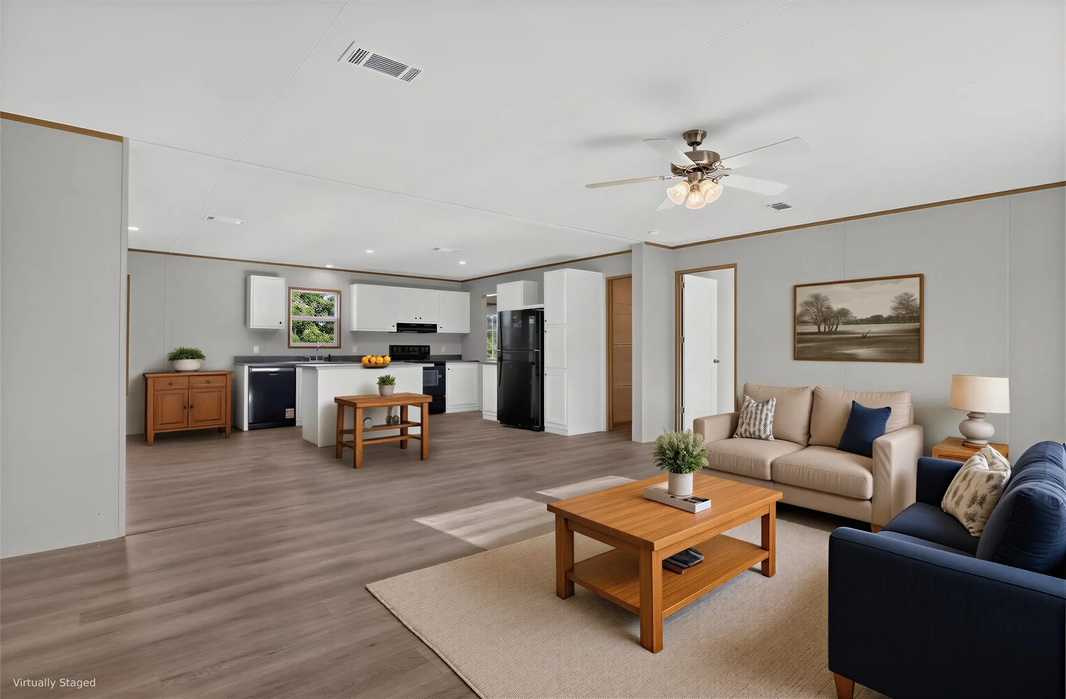 Open-concept living area featuring wood-finish flooring, a ceiling fan with integrated lighting, and recessed lighting.
Furniture is Virtually Staged