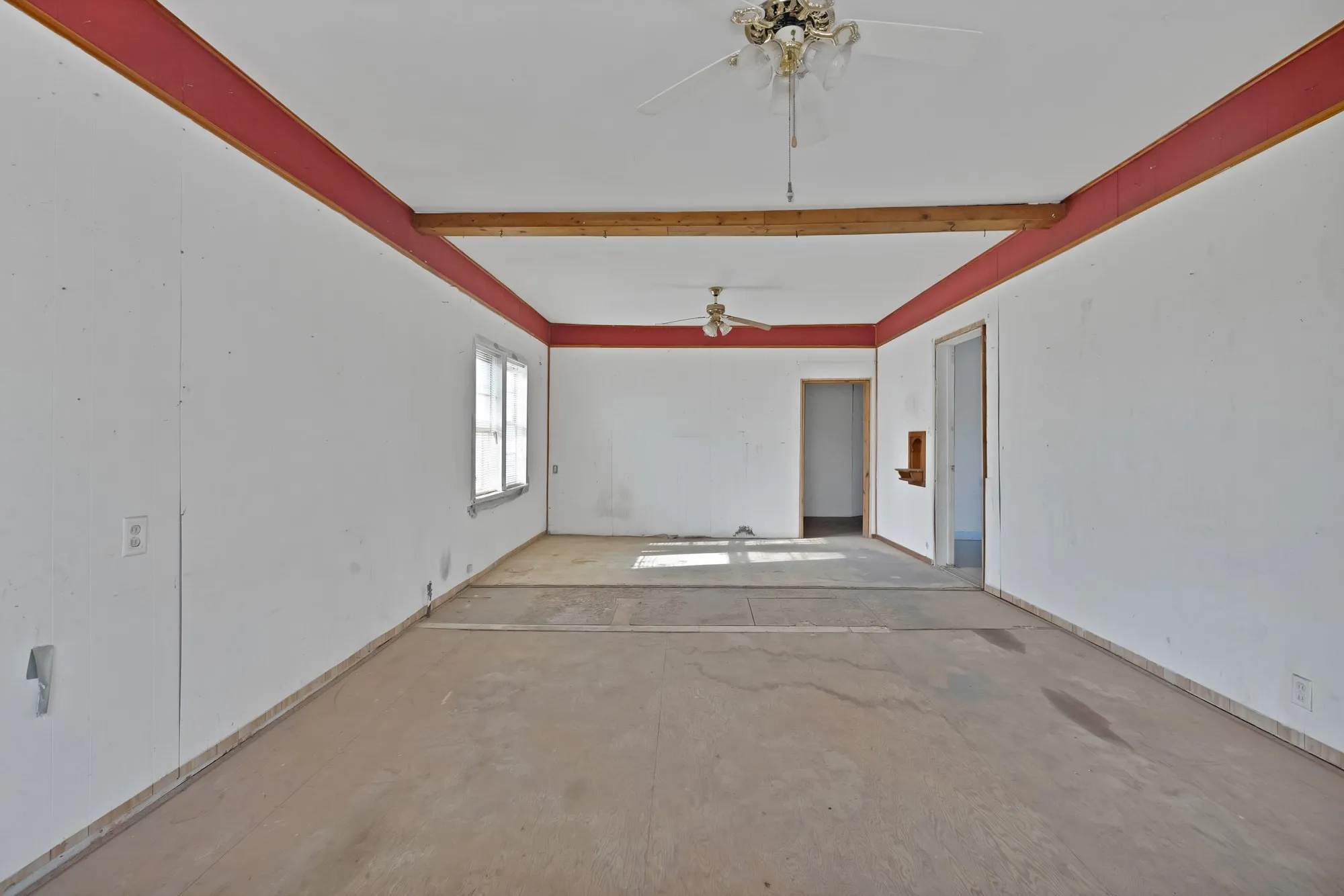 Spare room with unfinished concrete flooring and ceiling fan
