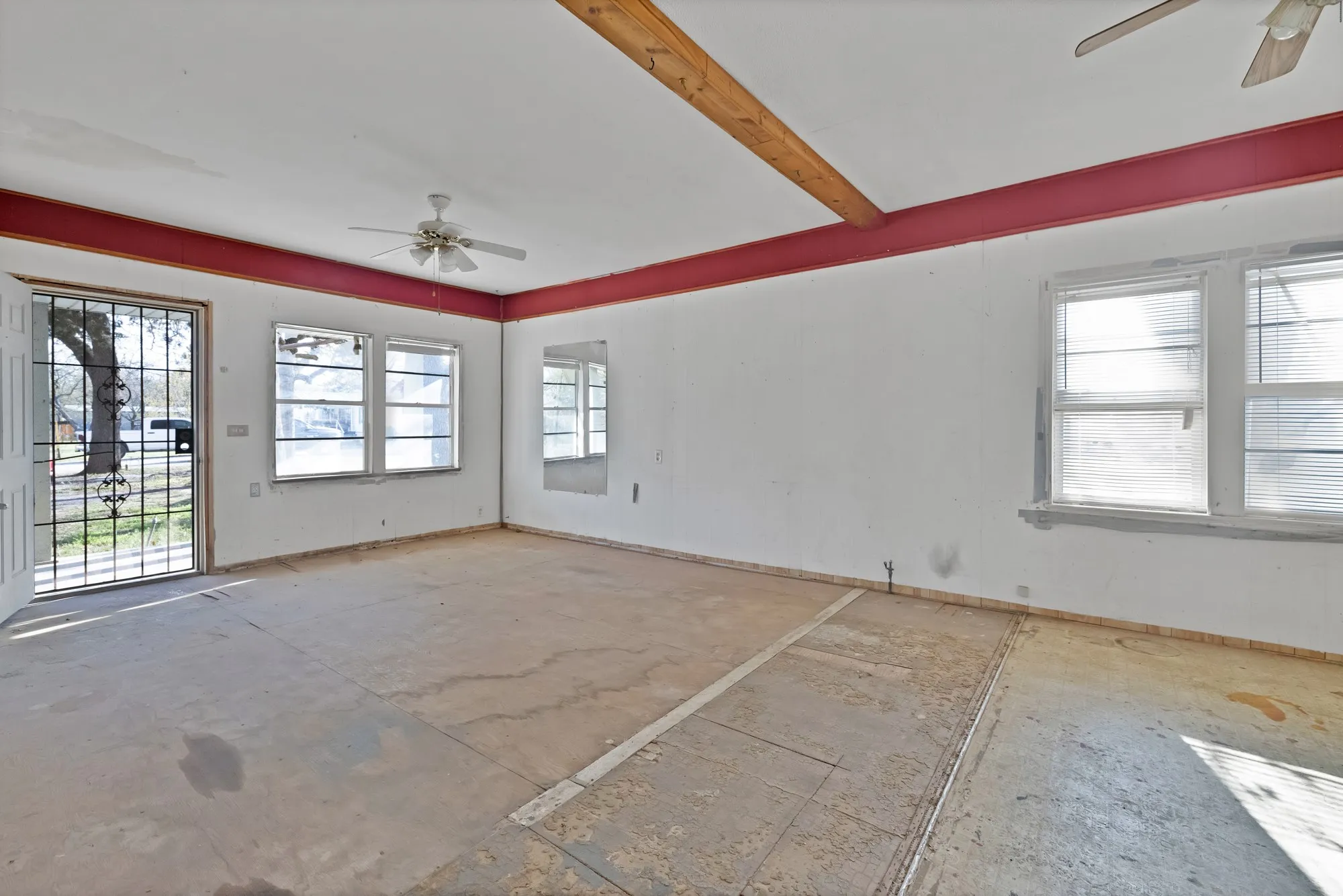 Spare room featuring a ceiling fan and plenty of natural light