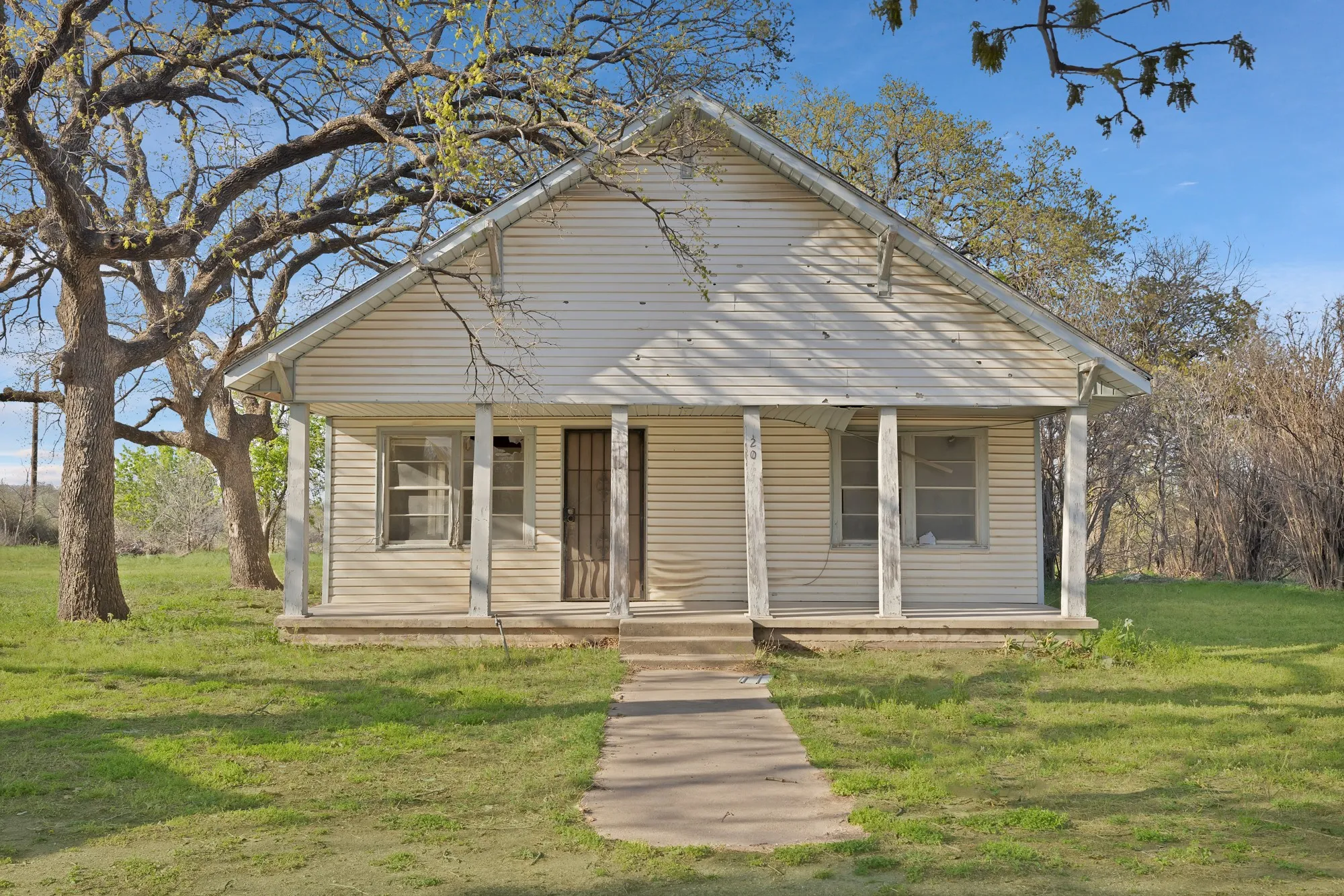Bungalow-style home with a porch and a front yard