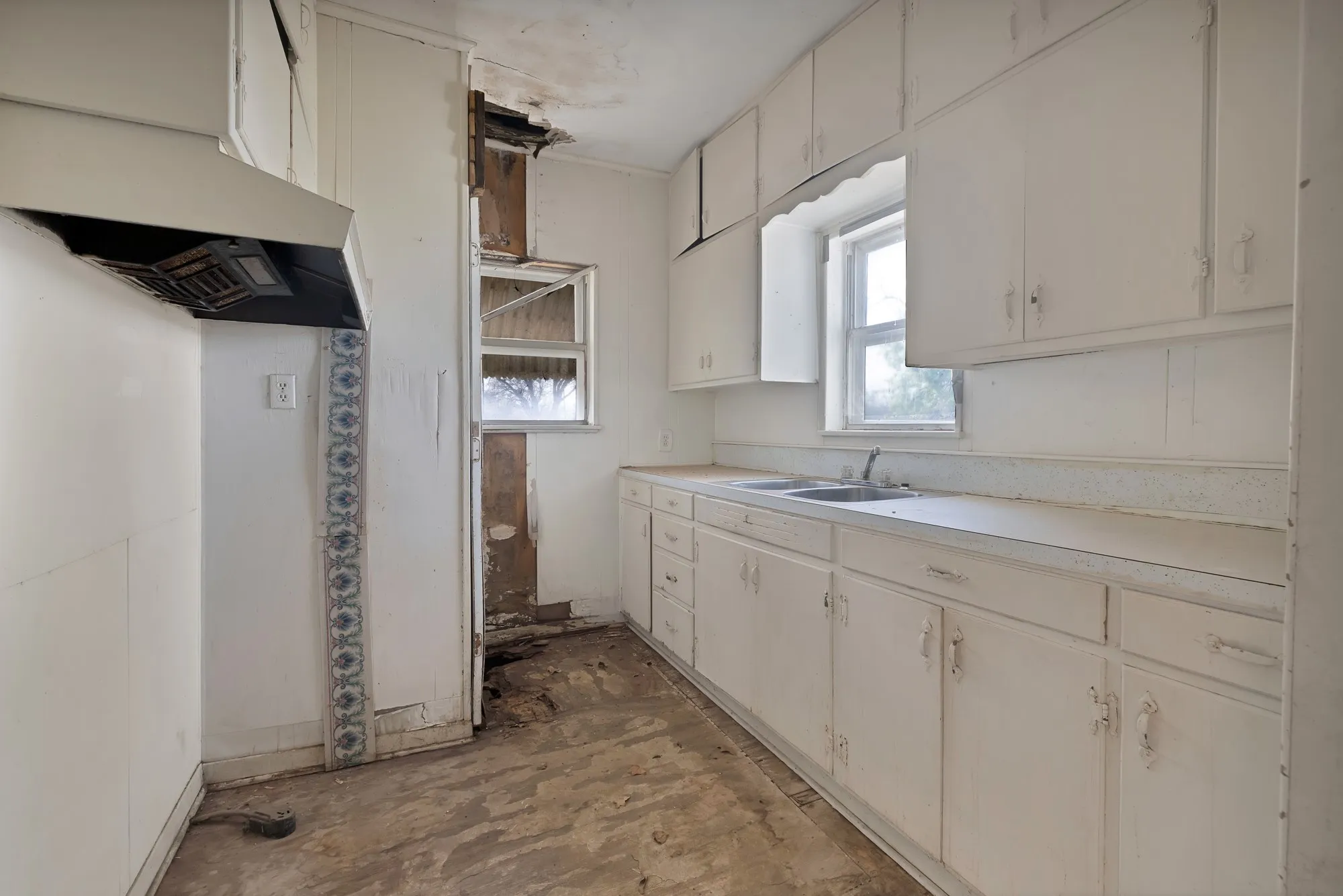 Kitchen with light countertops and white cabinetry
