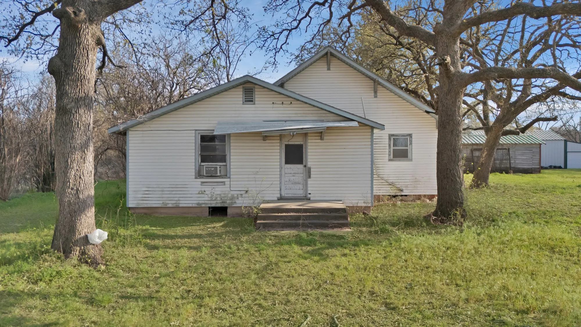 Back of property featuring a yard and crawl space