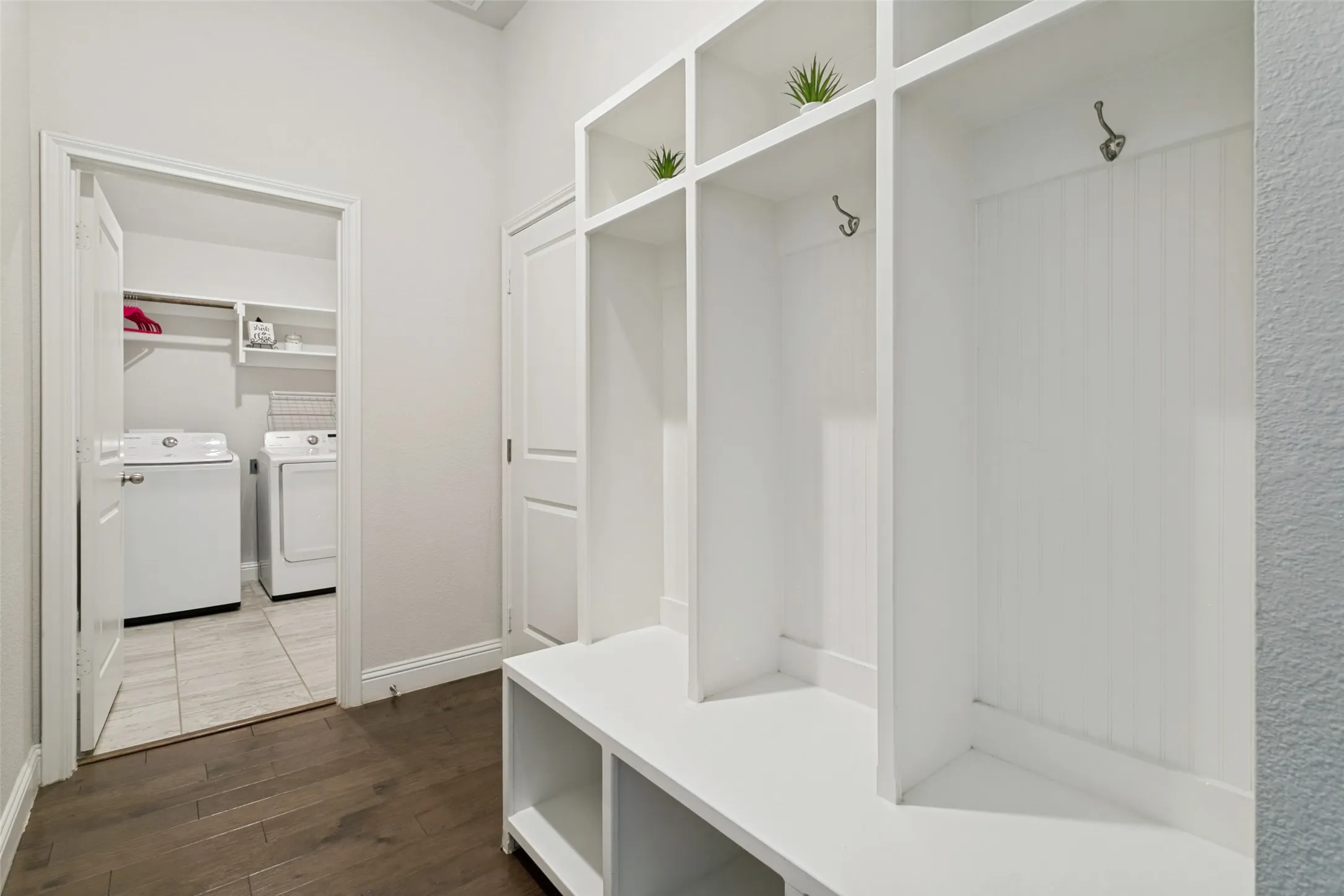 Utility room with washer and dryer off garage entry.