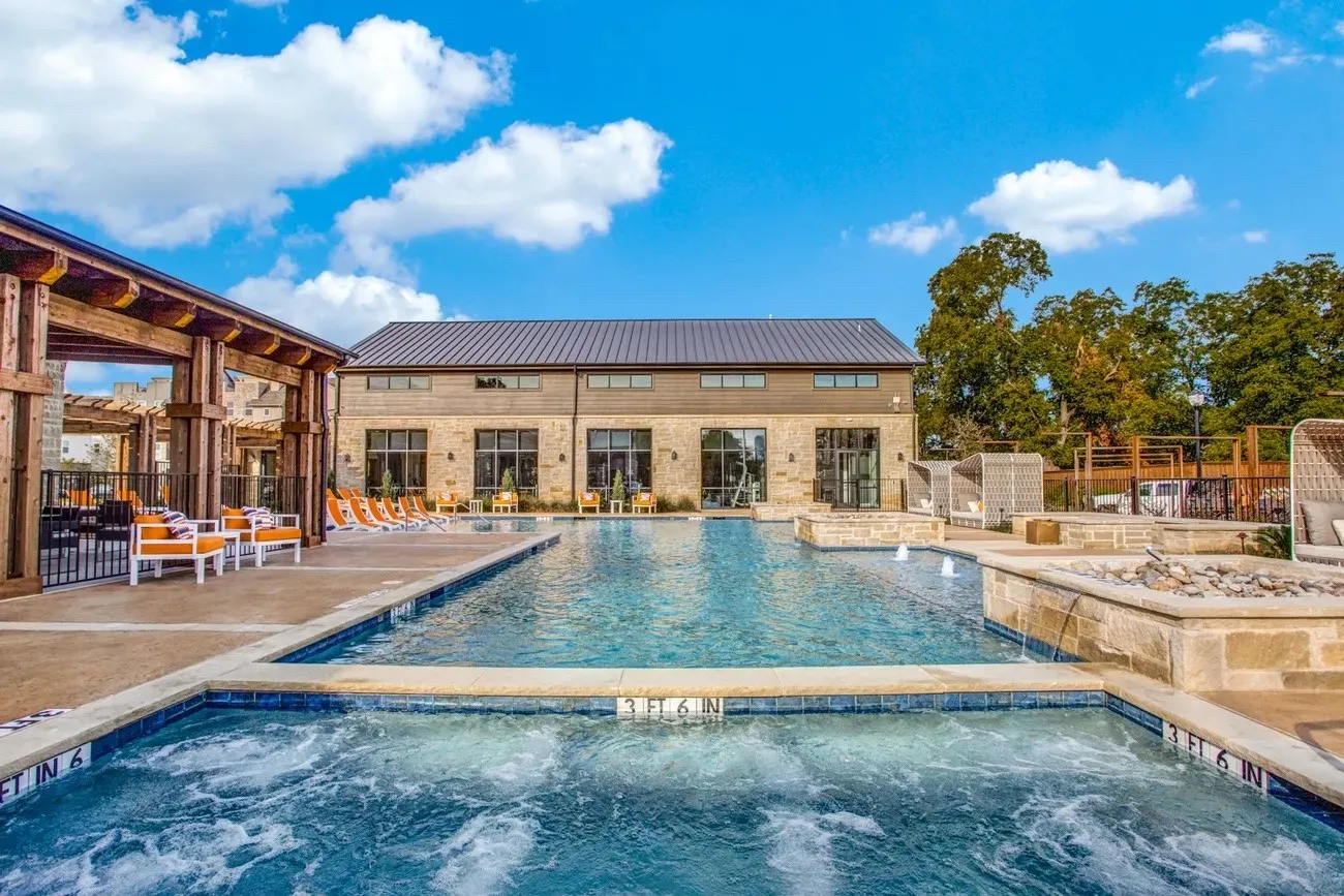 Resort-style pool with 12 person capacity hot tub.