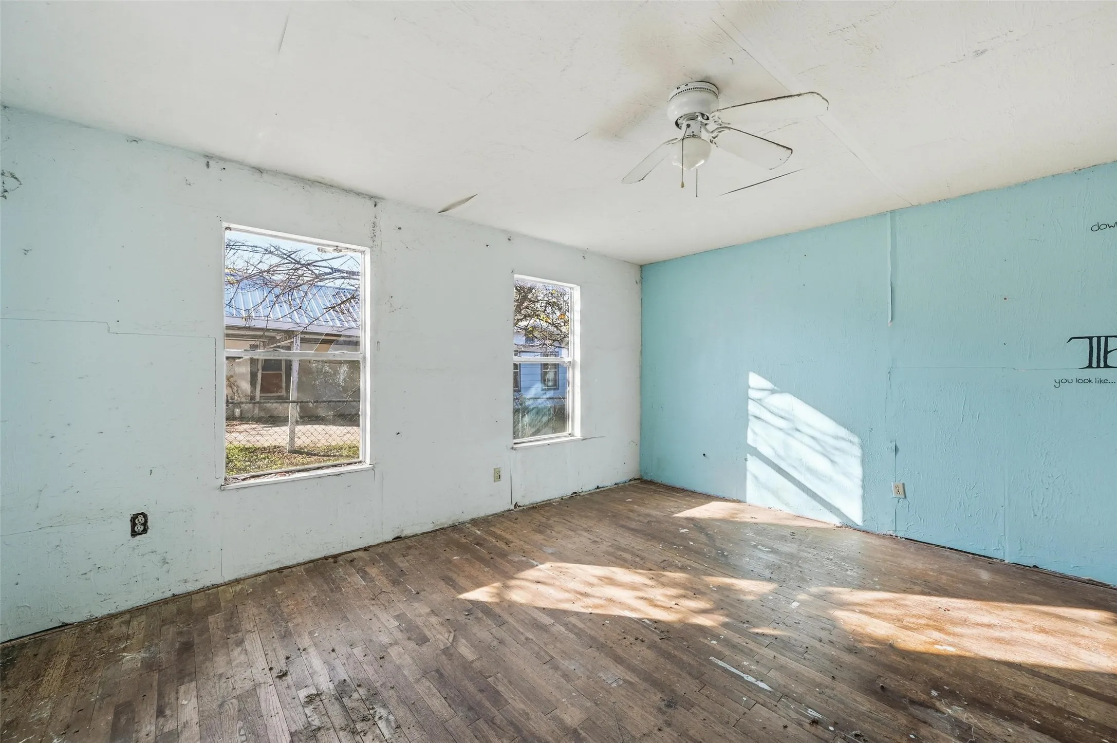 Spare room with hardwood / wood-style flooring and a ceiling fan