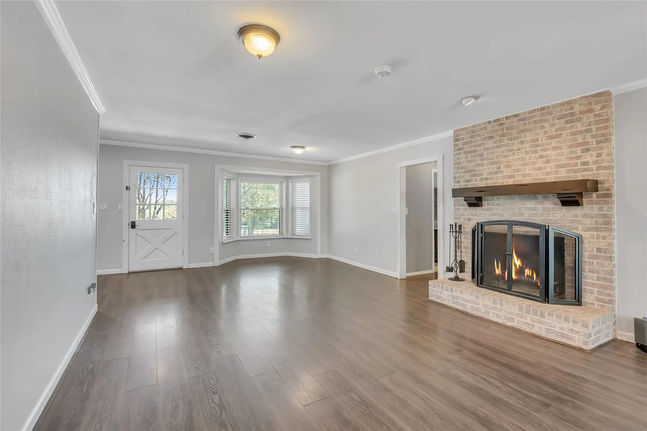 Brick fireplace with a substantial wood mantel