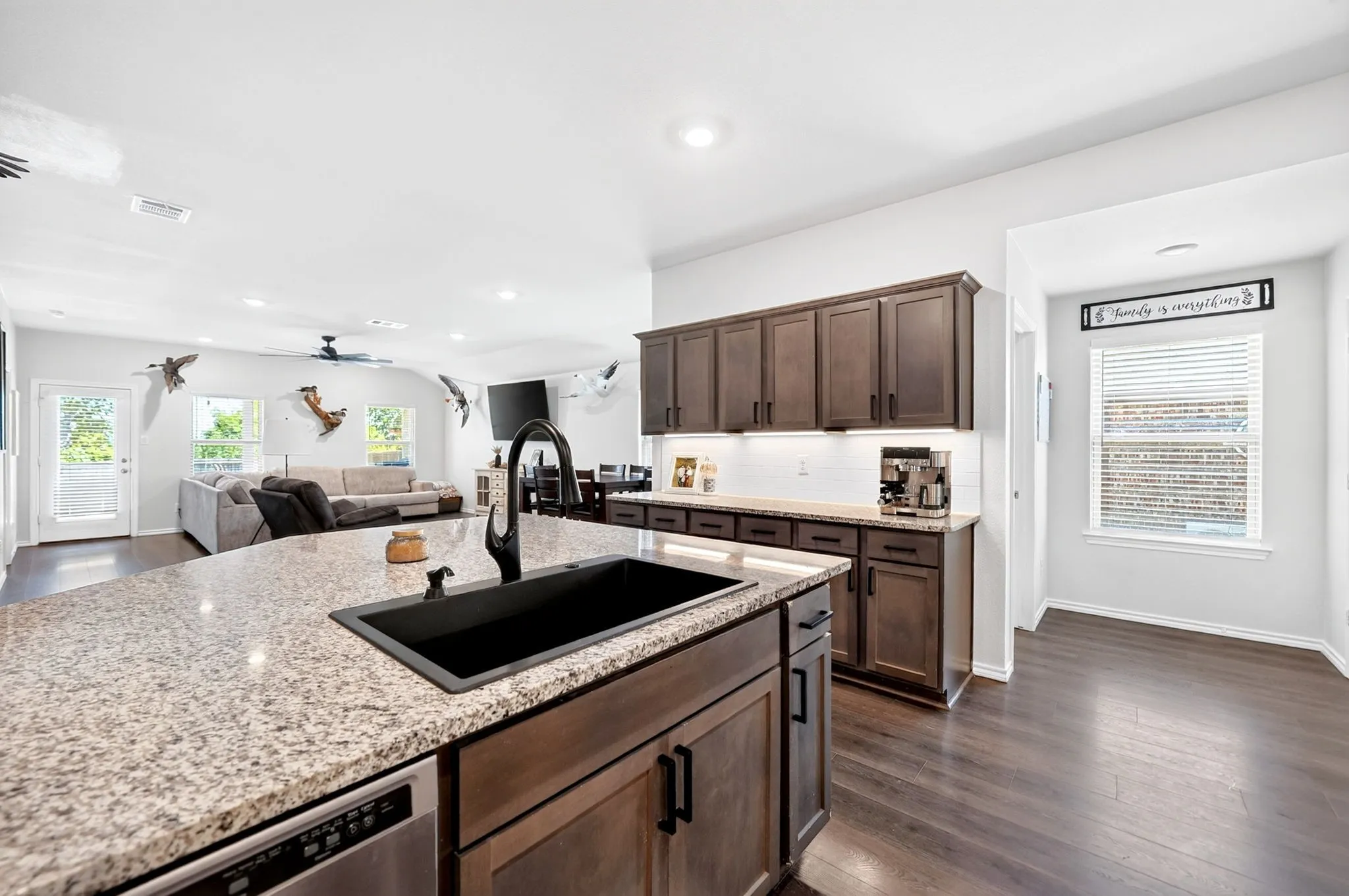 Expansive kitchen island with granite countertop and undermount sink