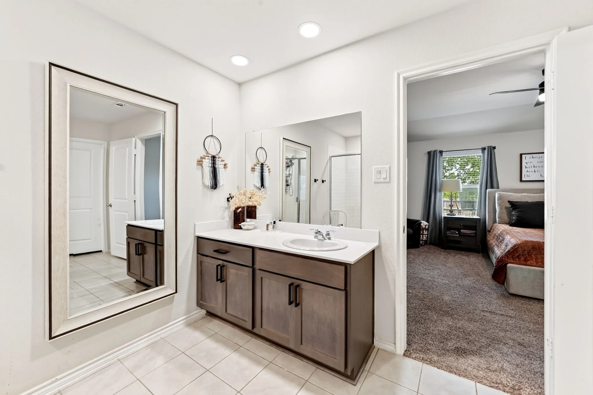 Vanity with shaker-style cabinetry, a white countertop, and a single basin sink