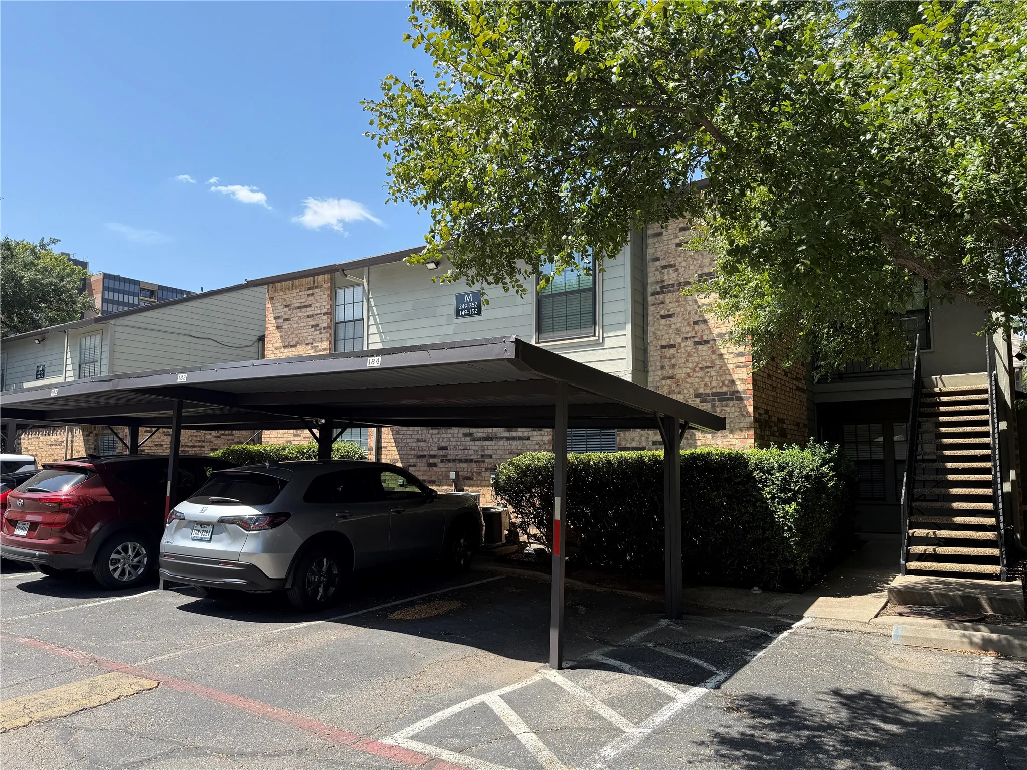 Brick and siding exterior with mature landscaping