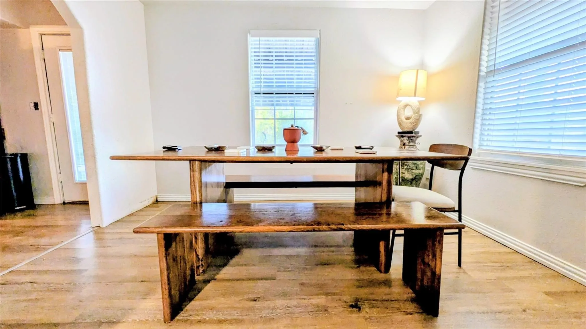 Laminate flooring throughout, white wall paint, and white window blinds