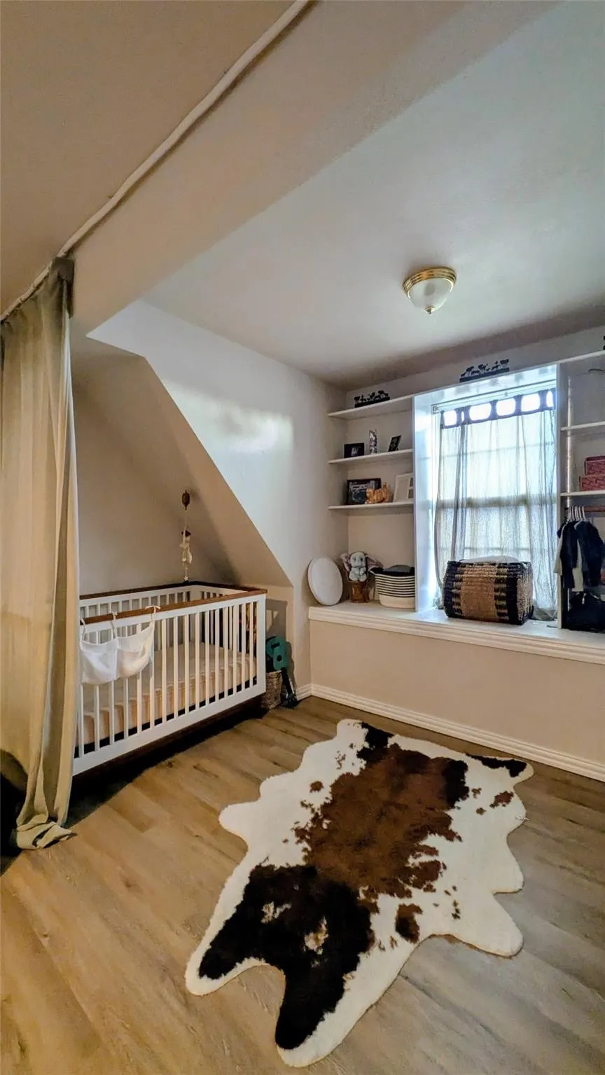 Laminate finish flooring, built-in shelving, and a window seat