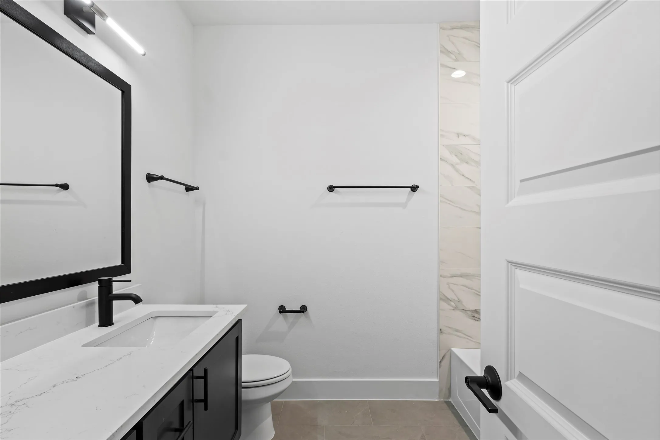Full bathroom with tile patterned flooring, vanity, bathing tub / shower combination, and toilet