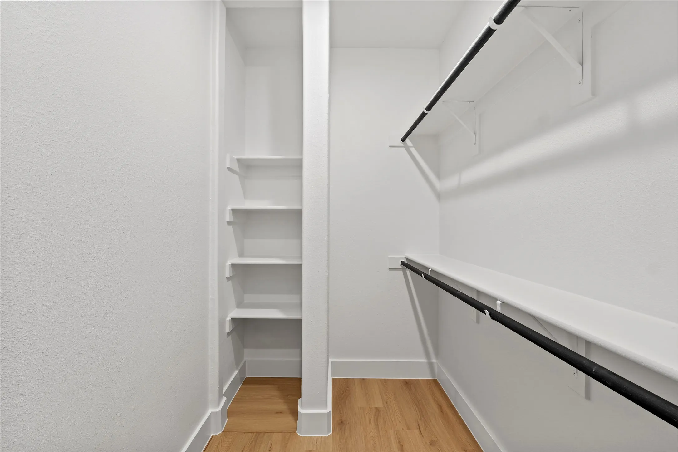 Spacious closet featuring light hardwood / wood-style floors