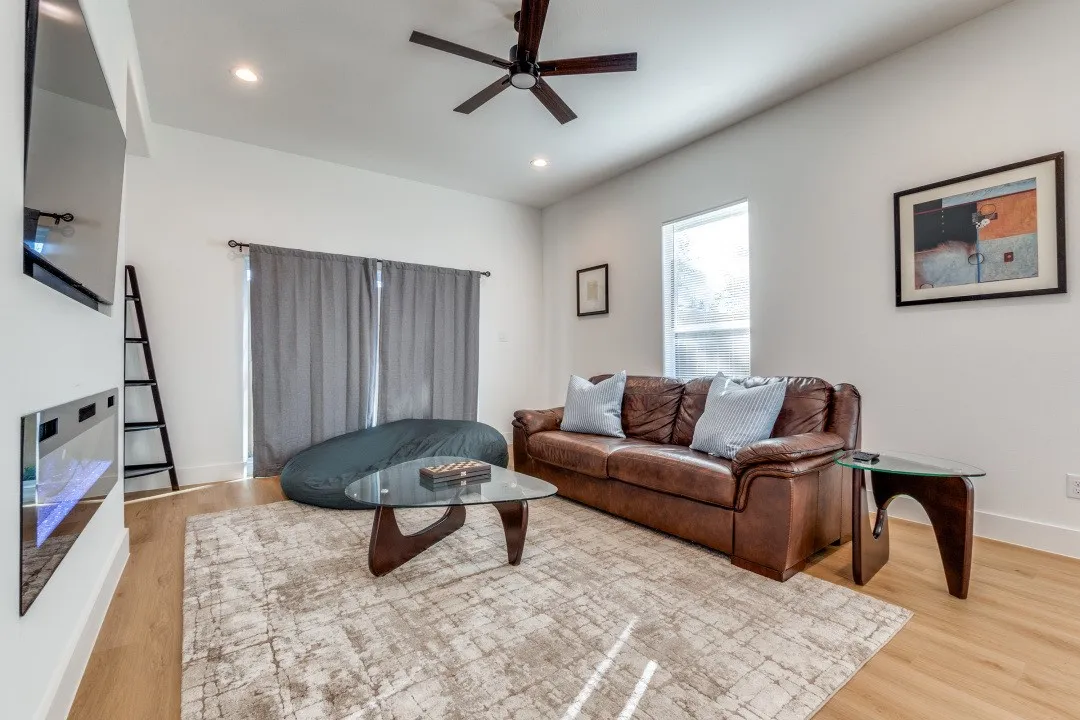 Living room featuring ceiling fan and light hardwood / wood-style flooring