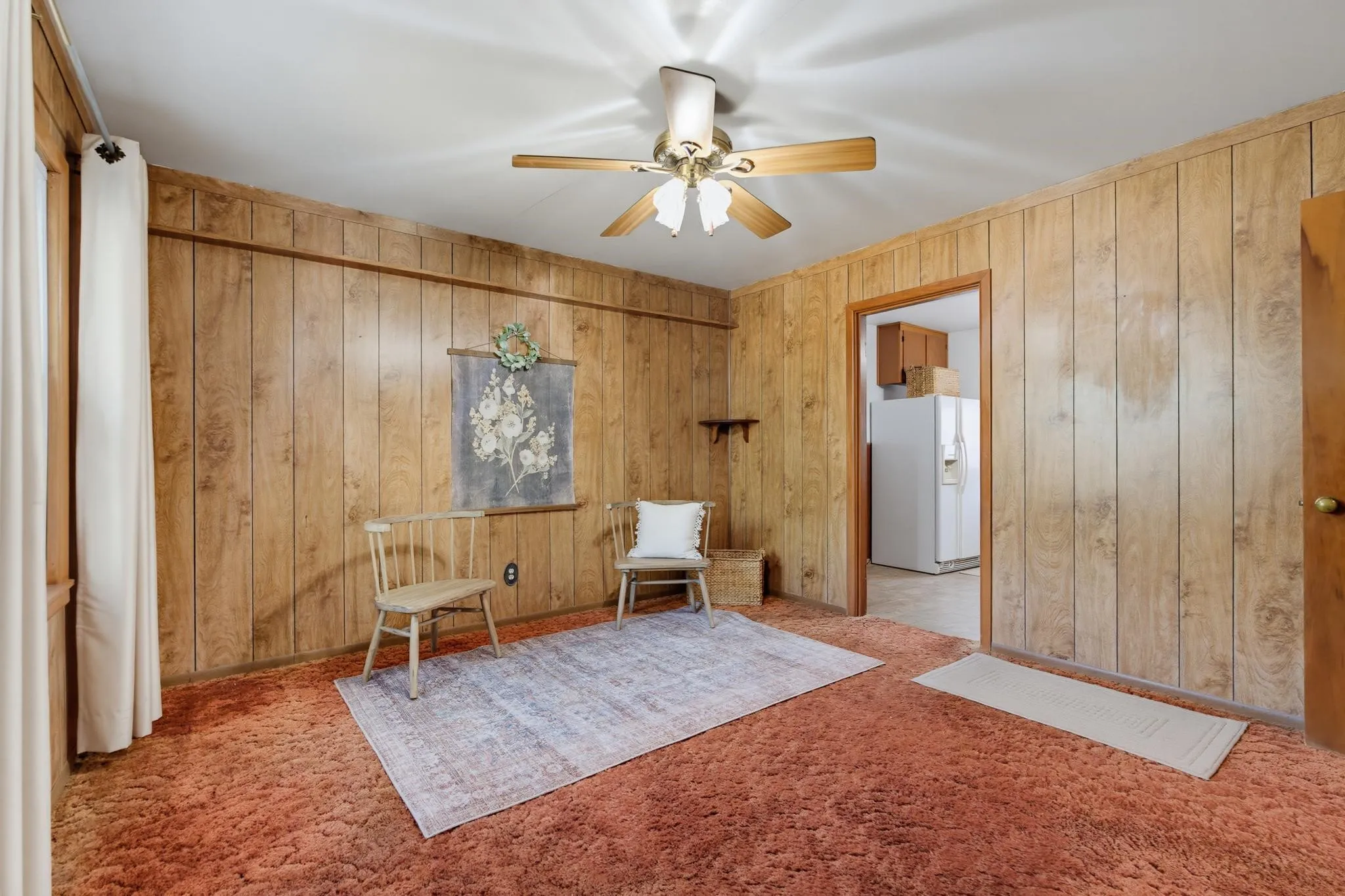 Living room has hard wood under carpet.