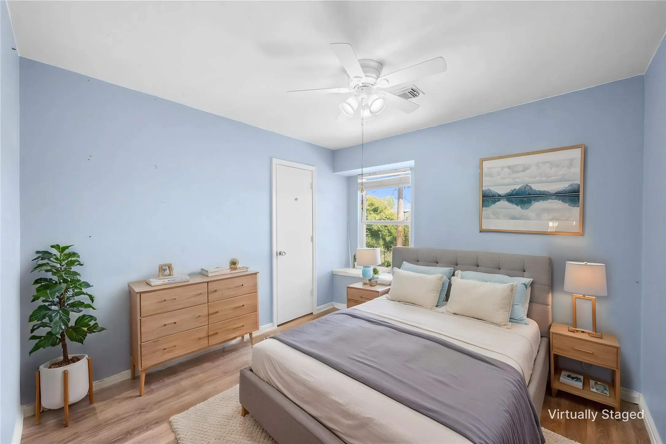 Wood-finish flooring, ceiling fan with integrated lighting, and a window with blinds