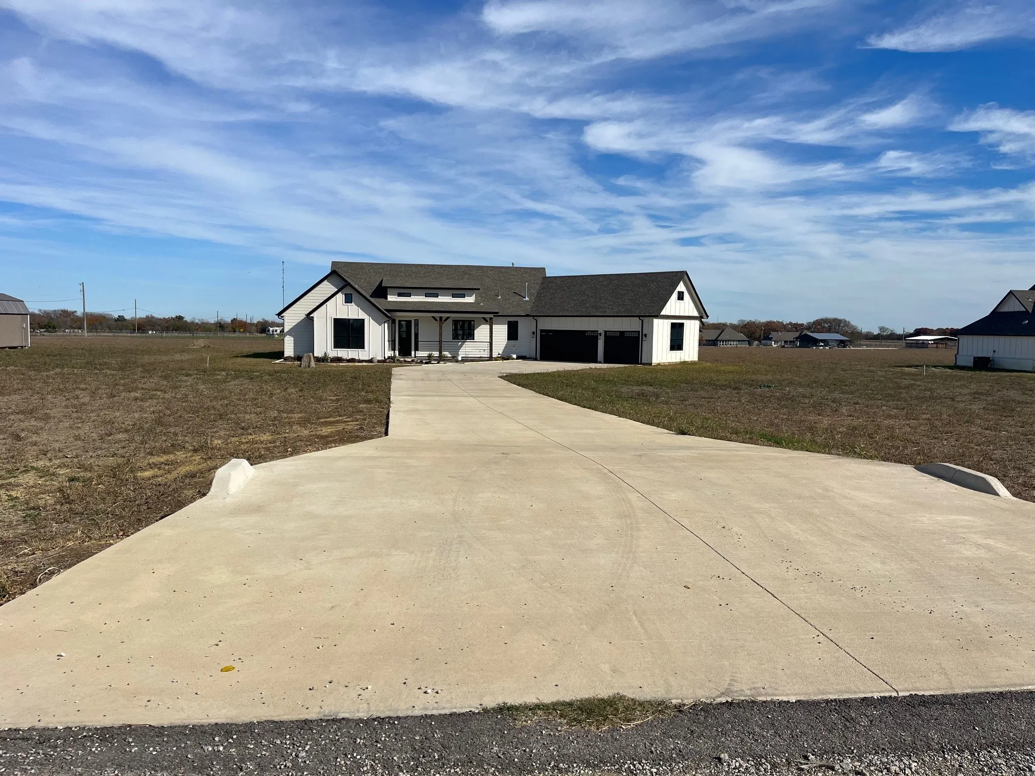 View of front of home with a front yard and a garage