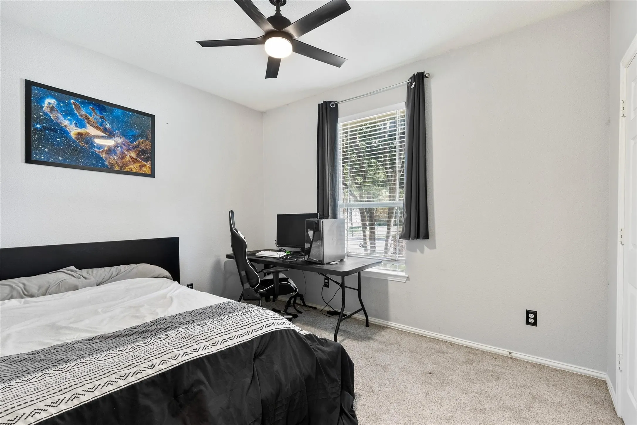 Carpeted flooring, window with blinds, ceiling fan with integrated lighting, and light-toned wall finishes
