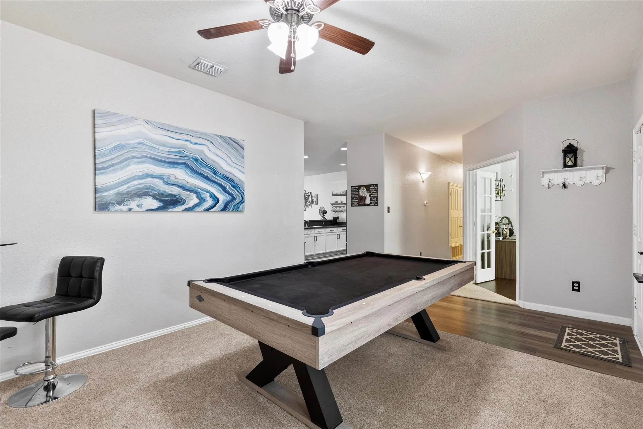 Carpeted flooring, ceiling fan with integrated lighting, and recessed wall niche with lighting
