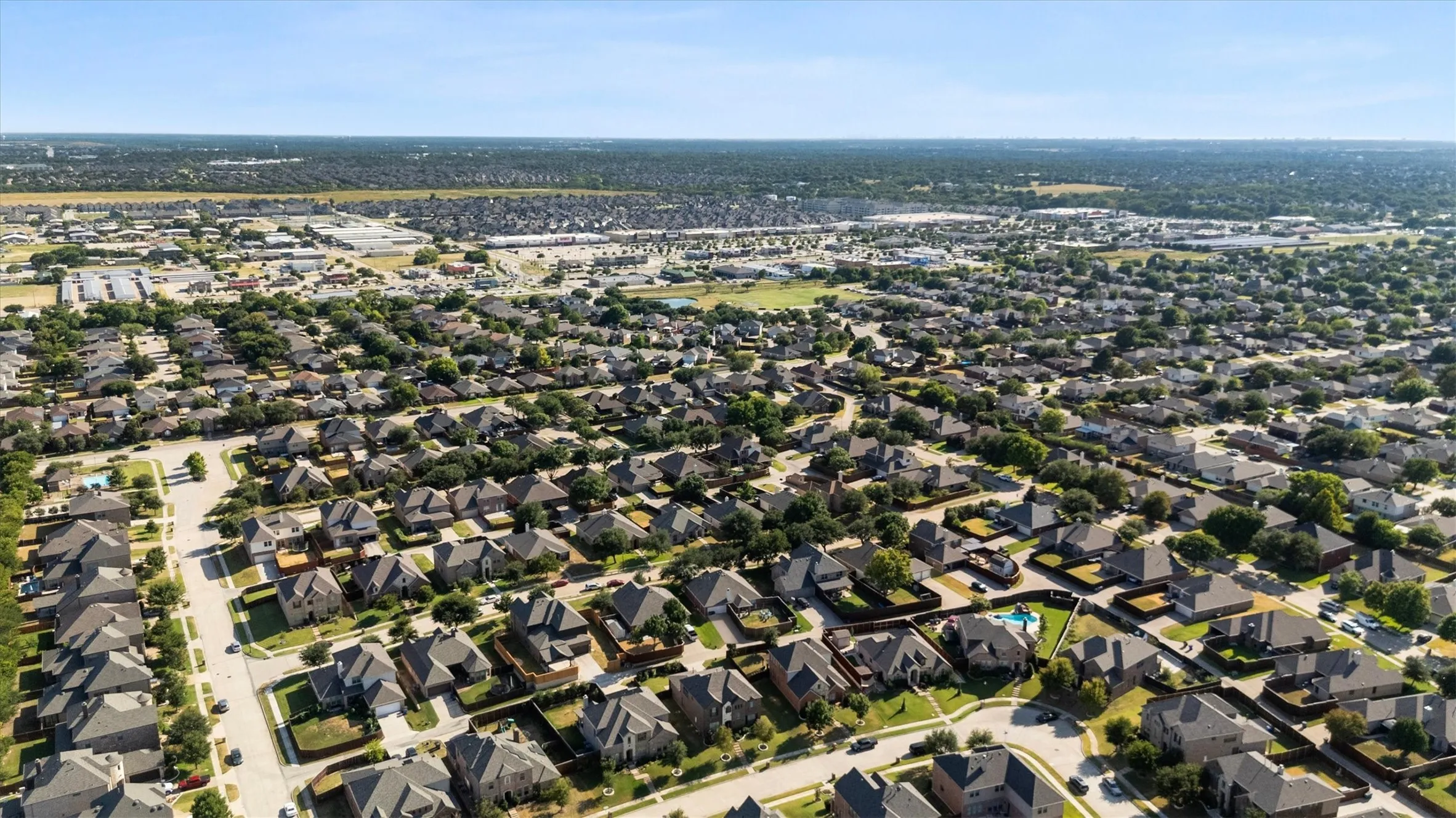 Residential neighborhood with a structured street grid and mature tree canopy