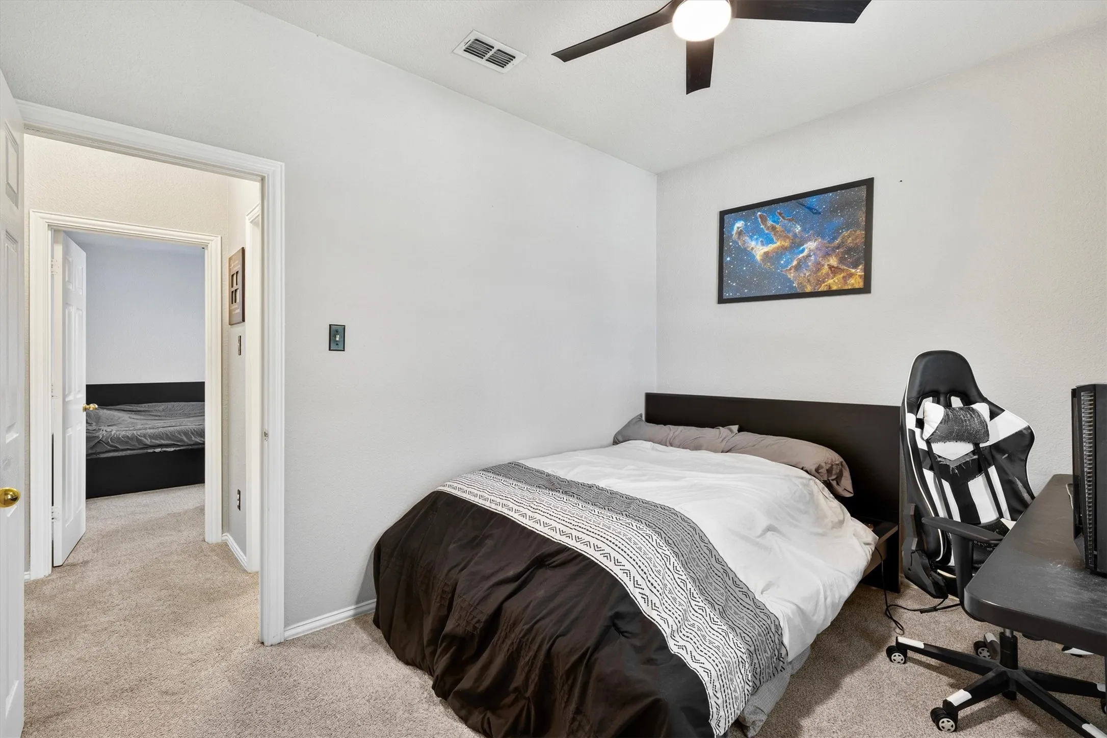 White painted walls, light-colored carpet, and a ceiling fan with integrated lighting