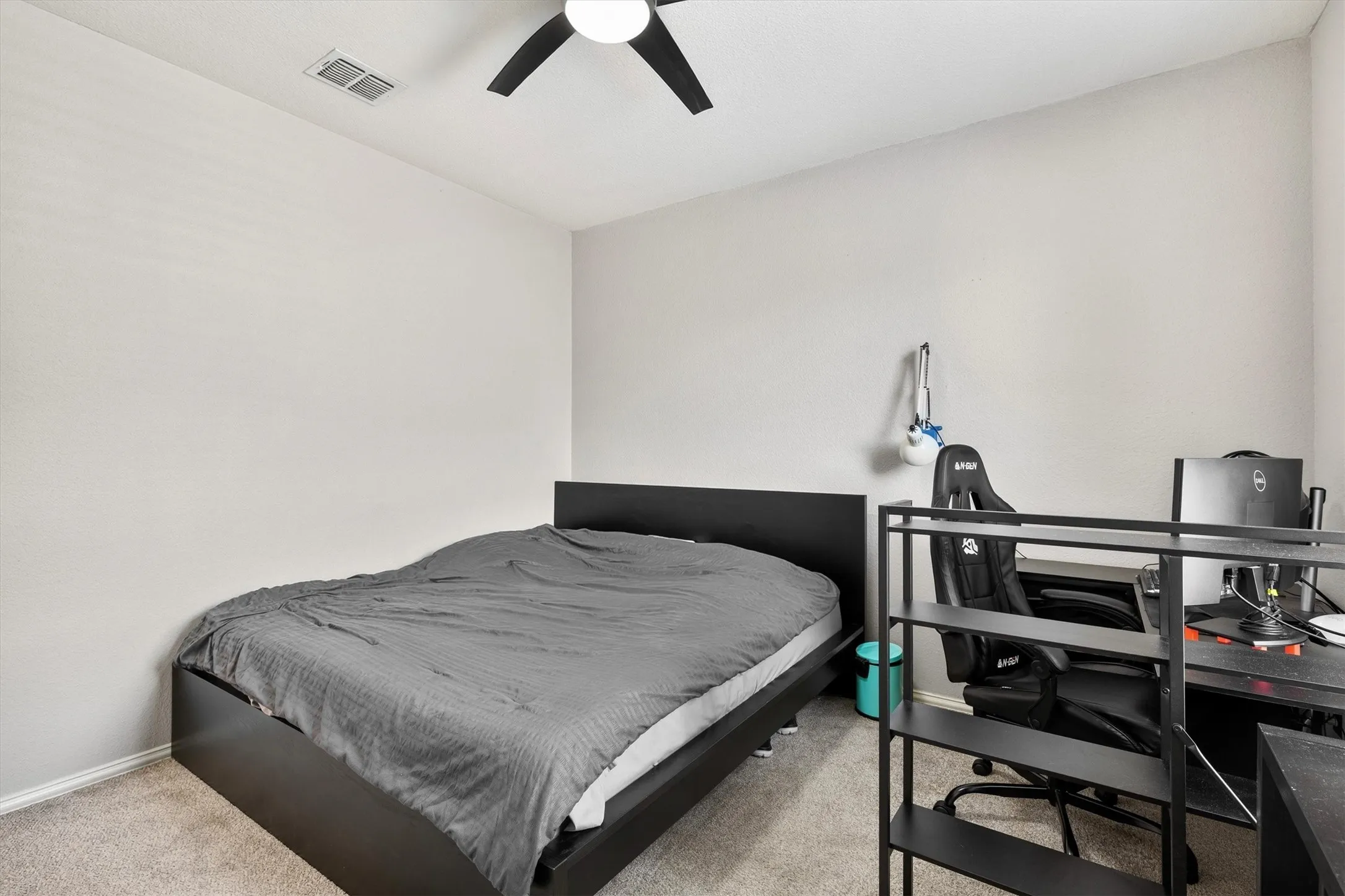 Carpeted flooring, neutral wall tones, and a ceiling fan with integrated lighting