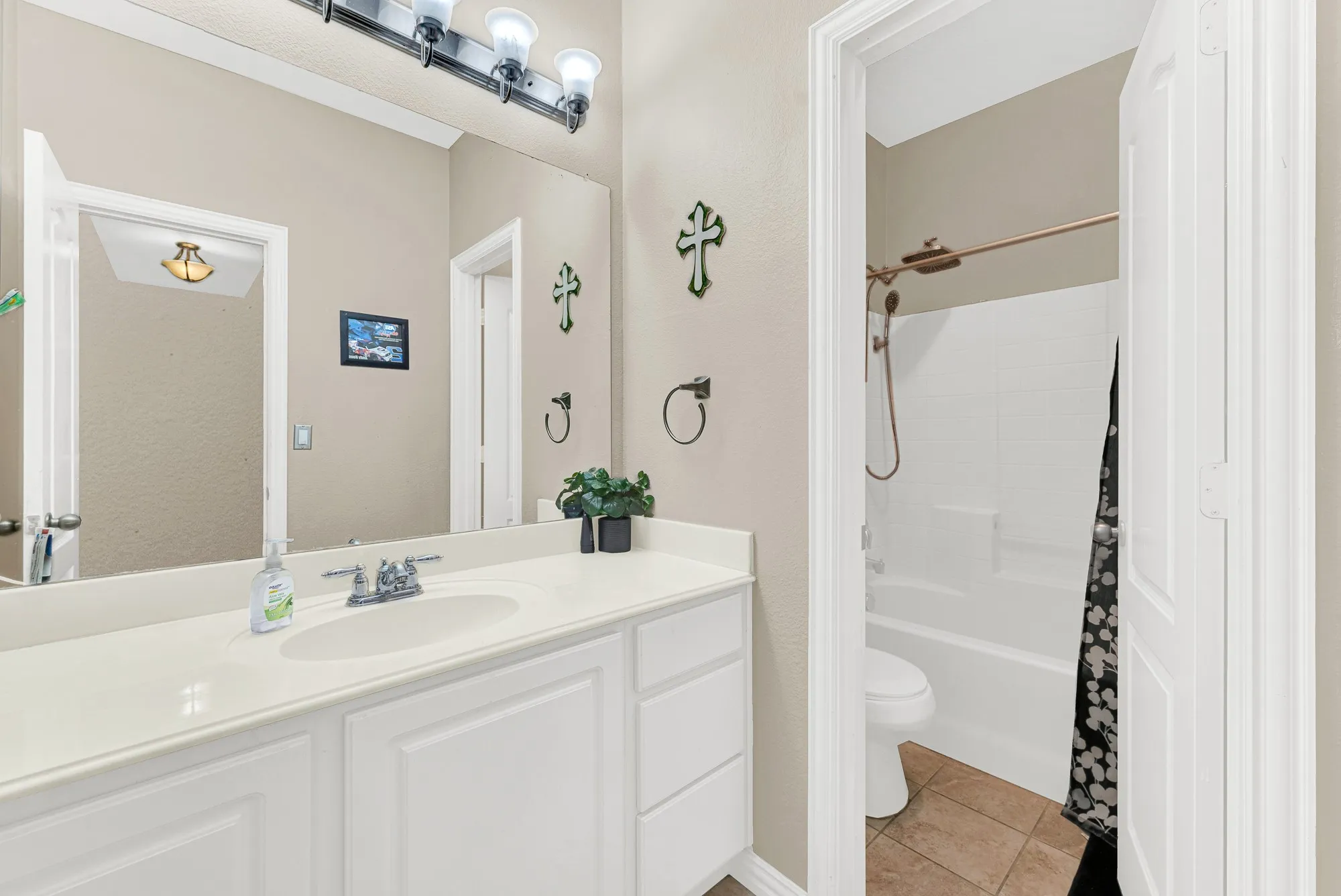 Vanity with an integrated sink, polished chrome faucet, and ample storage cabinetry
