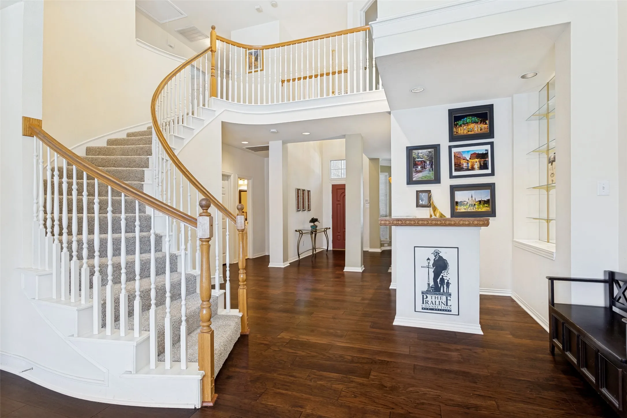 Nice curved staircase with newer carpet with a large Wet bar to the right