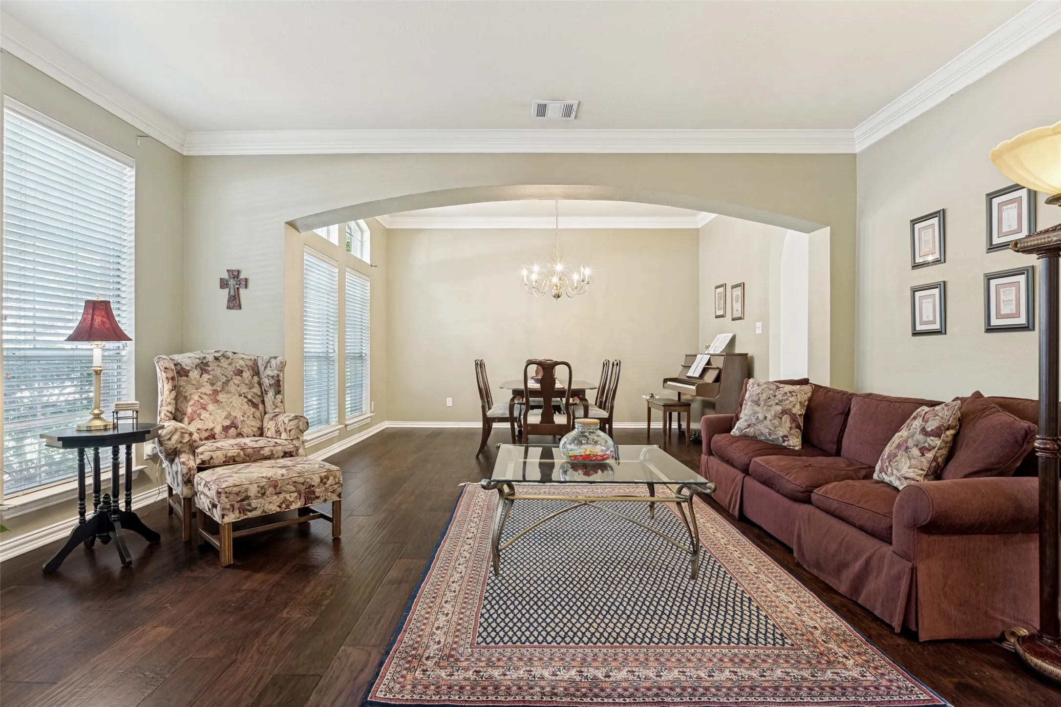 Front living area opens to formal dining with wall of windows