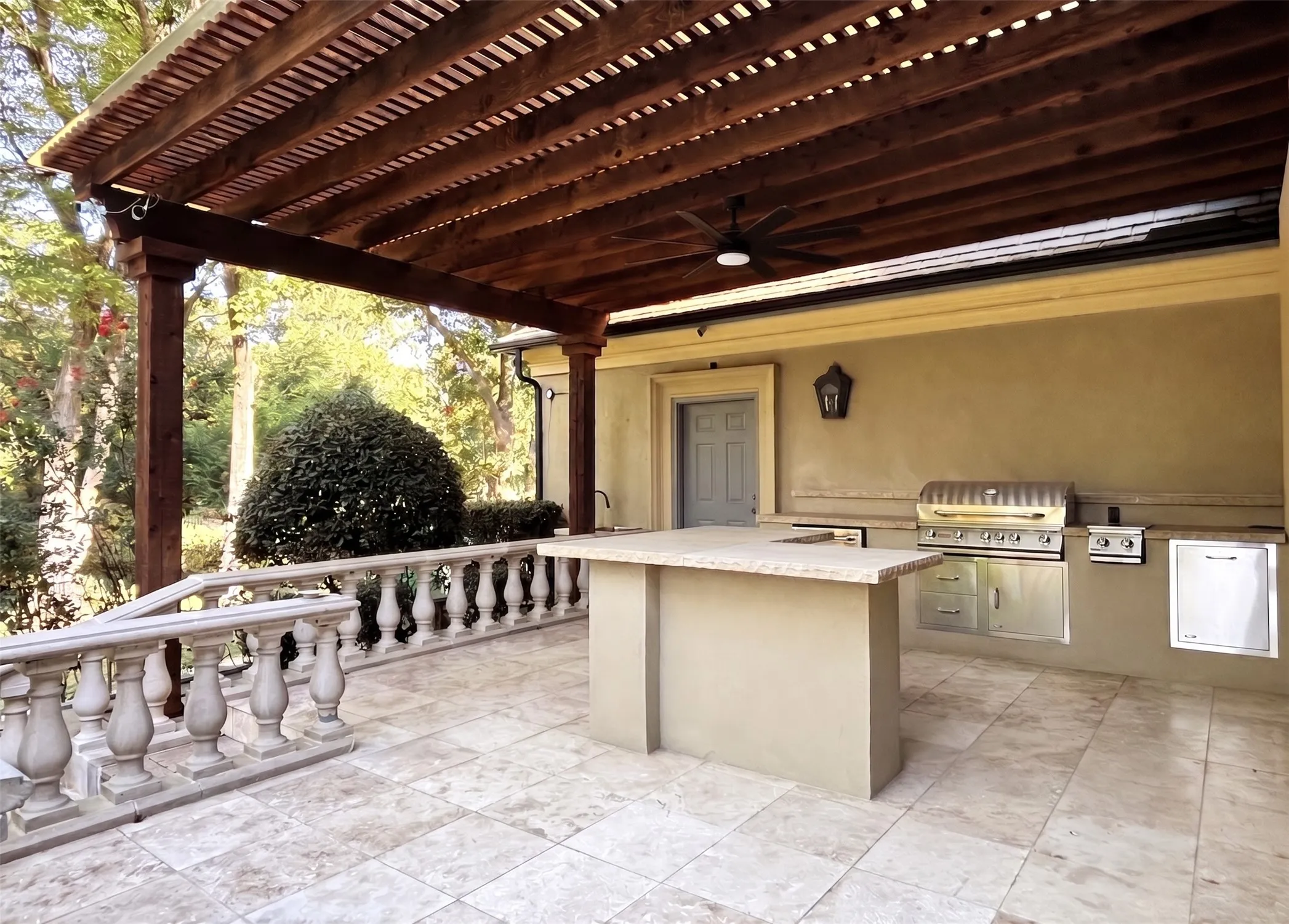 Host weekend barbeques with the pergola-covered outdoor kitchen