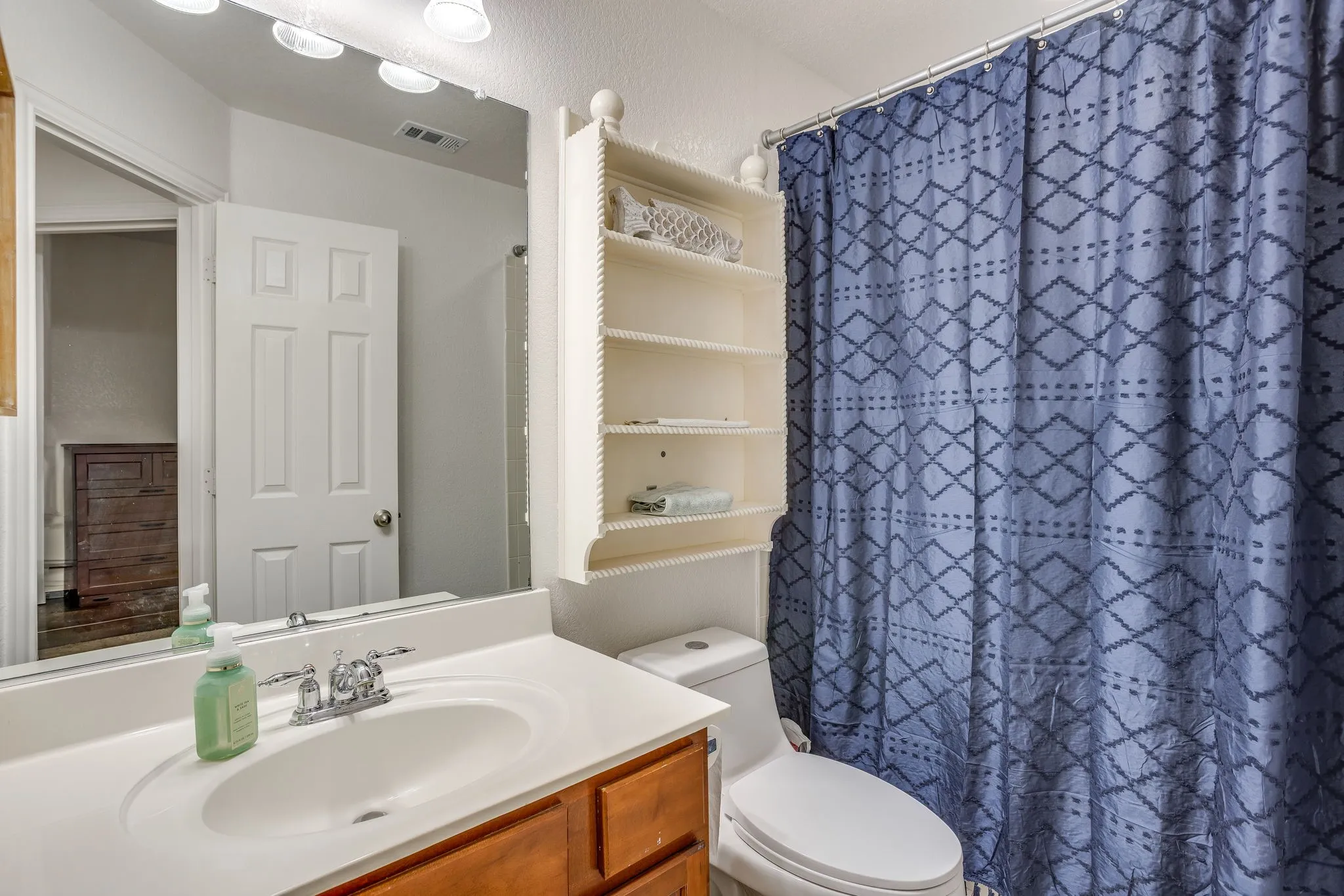 White vanity with integrated sink and chrome faucet