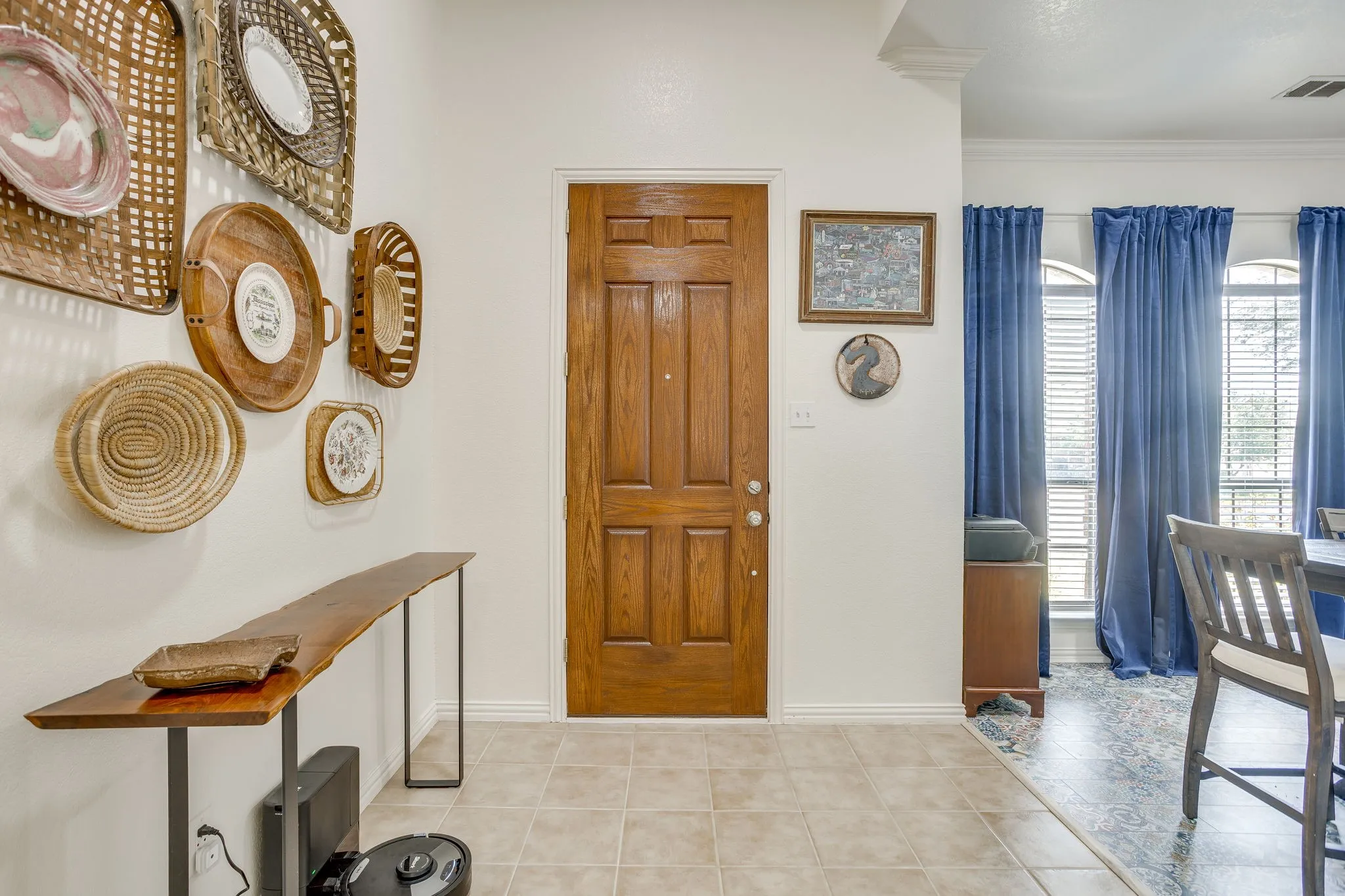 Panel wood entry door, crown molding, and arched window