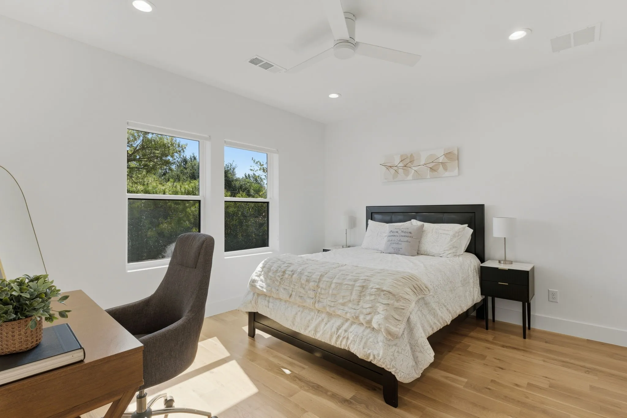 Hardwood flooring, recessed lighting, white walls, dual windows, and a ceiling fan