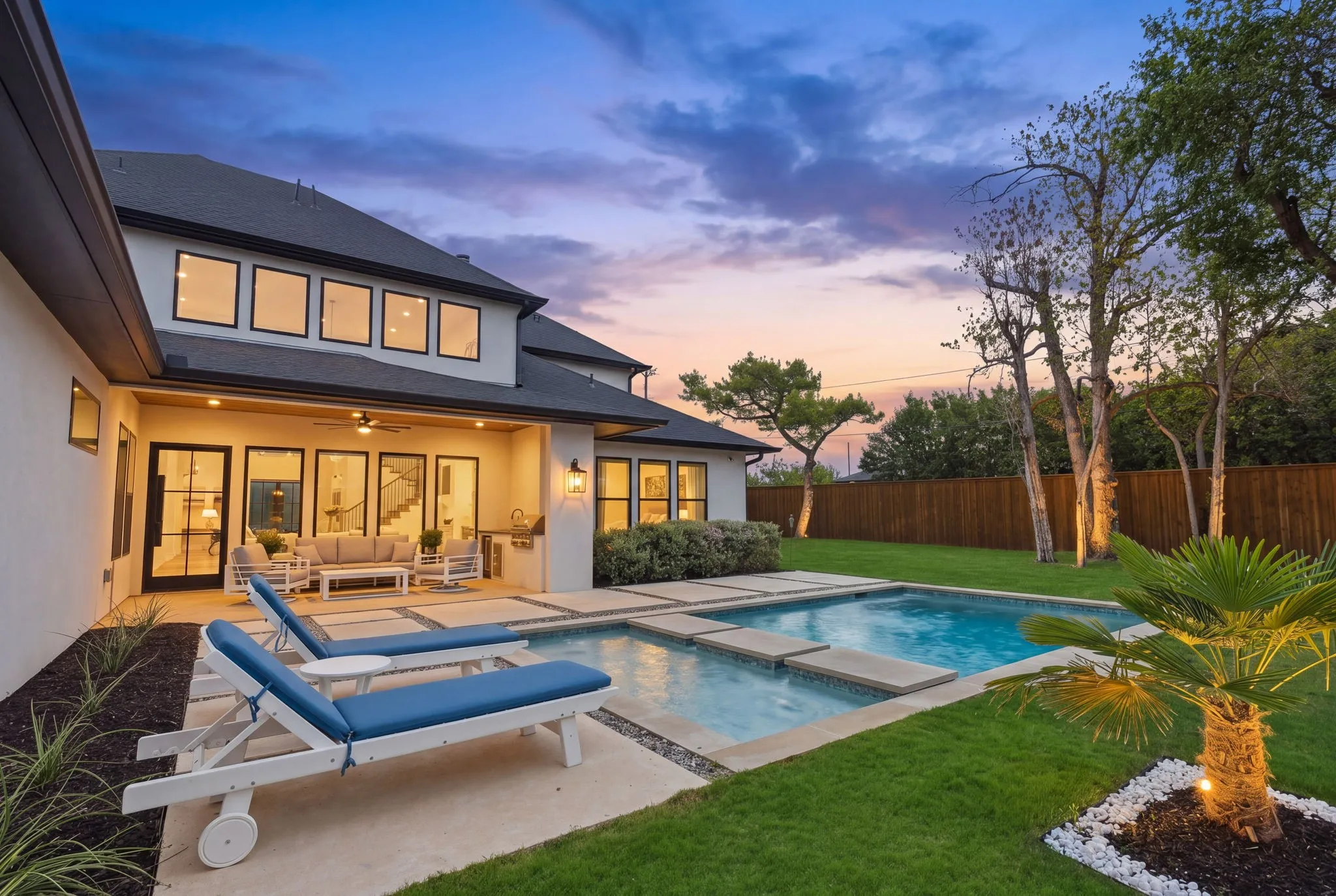 Expansive backyard featuring a rectangular swimming pool, integrated spa, and a covered patio with recessed lighting