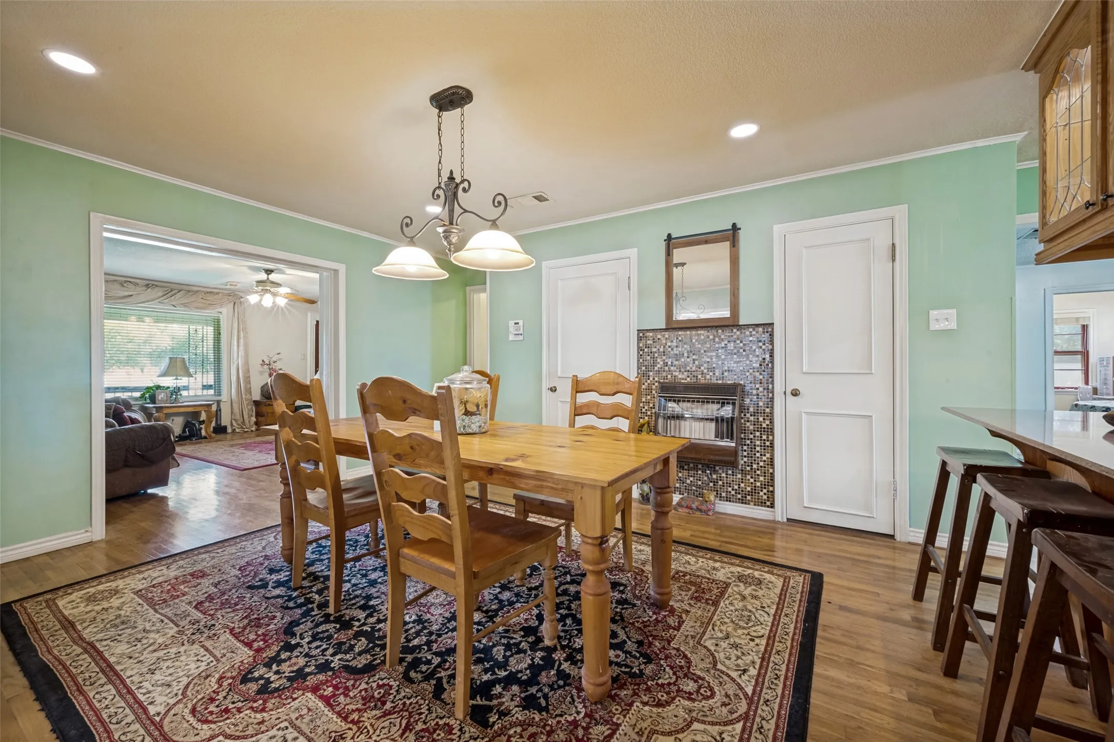 Wood-finish flooring throughout, featuring a built-in tiled fireplace