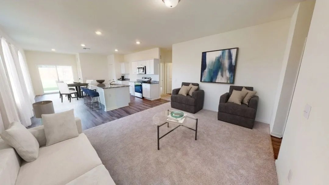 Open concept living area with recessed lighting, wood-finish flooring, and a kitchen island with seating