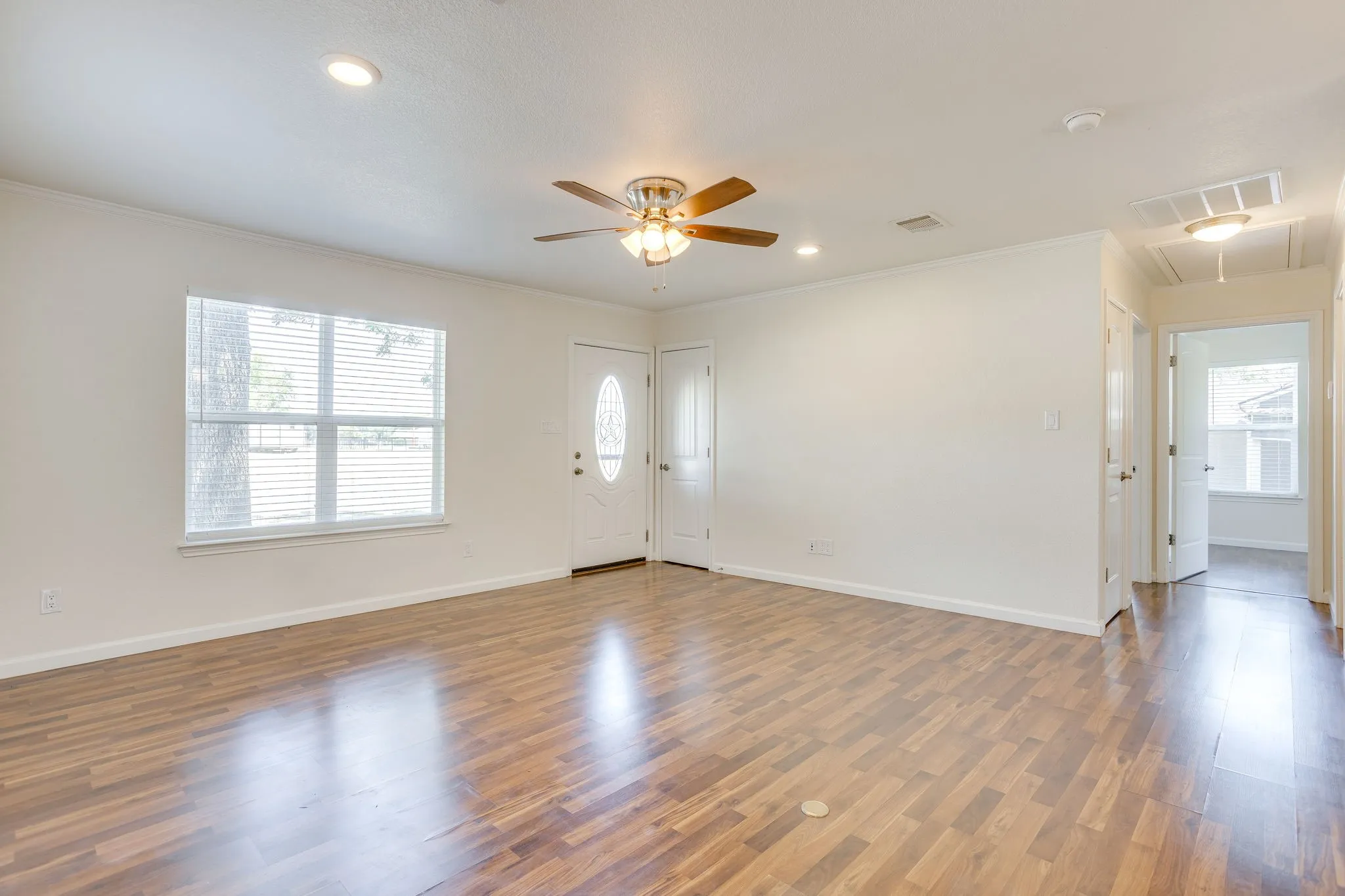 wood laminate flooring, natural light from front windows