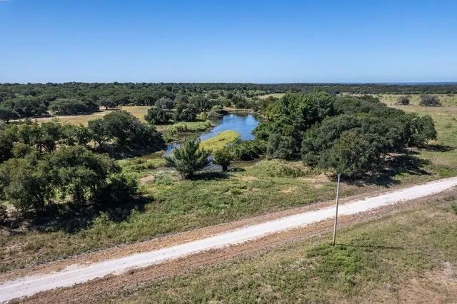 Far view of lot with pond