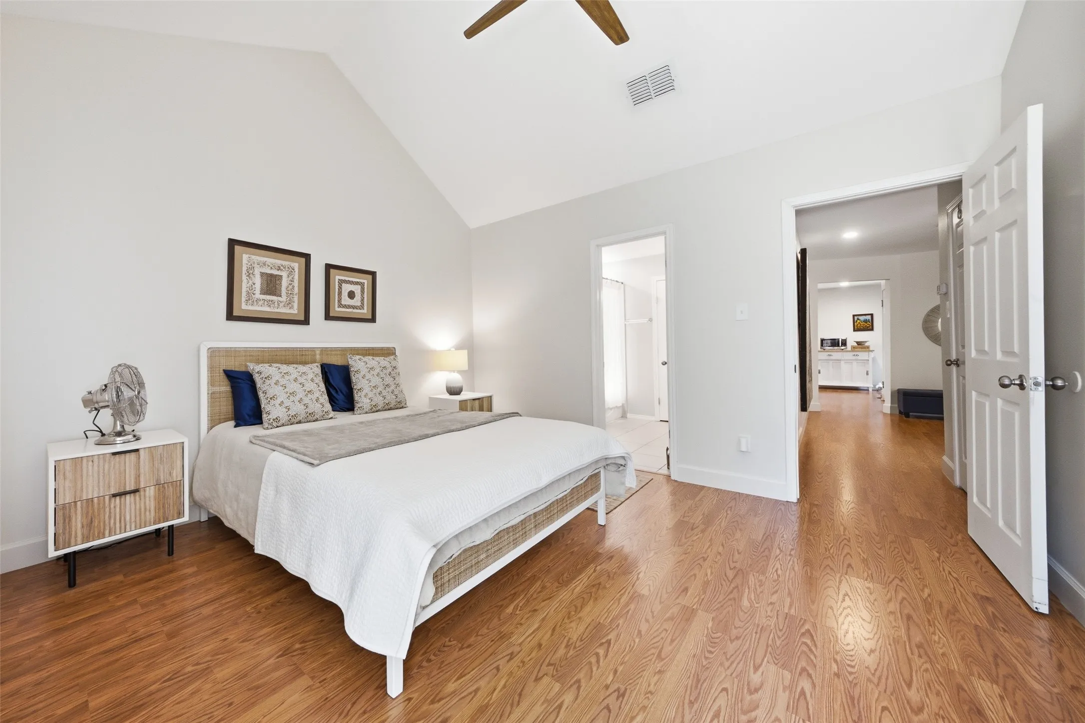A spacious primary bedroom with high ceilings, direct access to the en-suite bath, and a walk-in closet — everything in one well-organized footprint on the main floor.