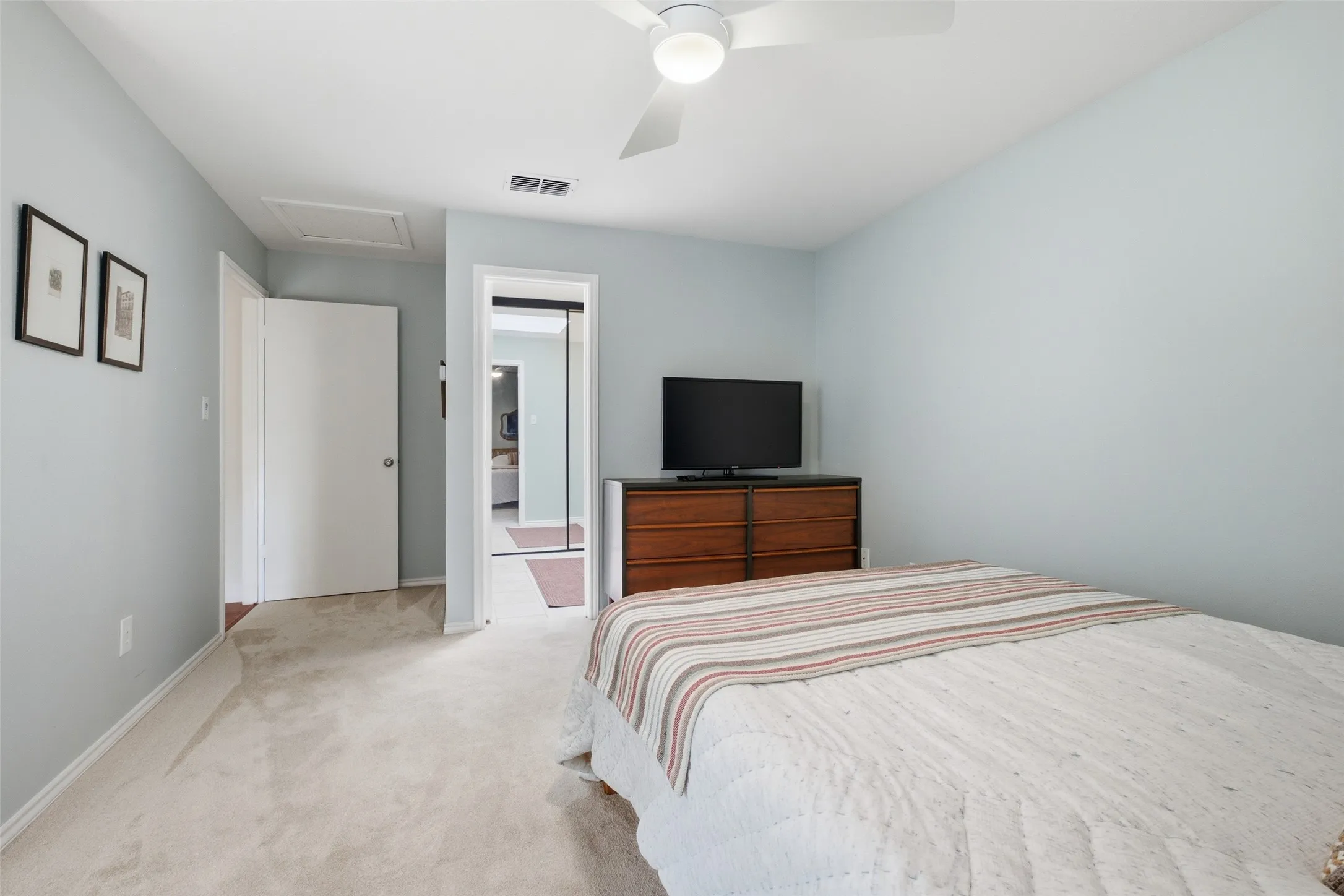 Another angle of the second bedroom, showing the room's size and the easy access to the upstairs bath just through the adjoining door.