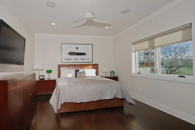 Wood-finish flooring, recessed lighting, crown molding, and a ceiling fan with integrated lighting