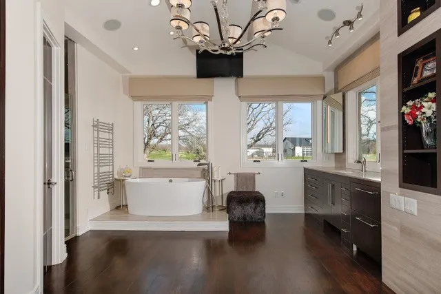 Vaulted ceiling with an ornate chandelier and recessed lighting
