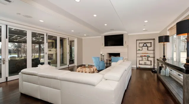 Hardwood flooring, recessed lighting, crown molding, fireplace with mantel, and accordion-style patio doors