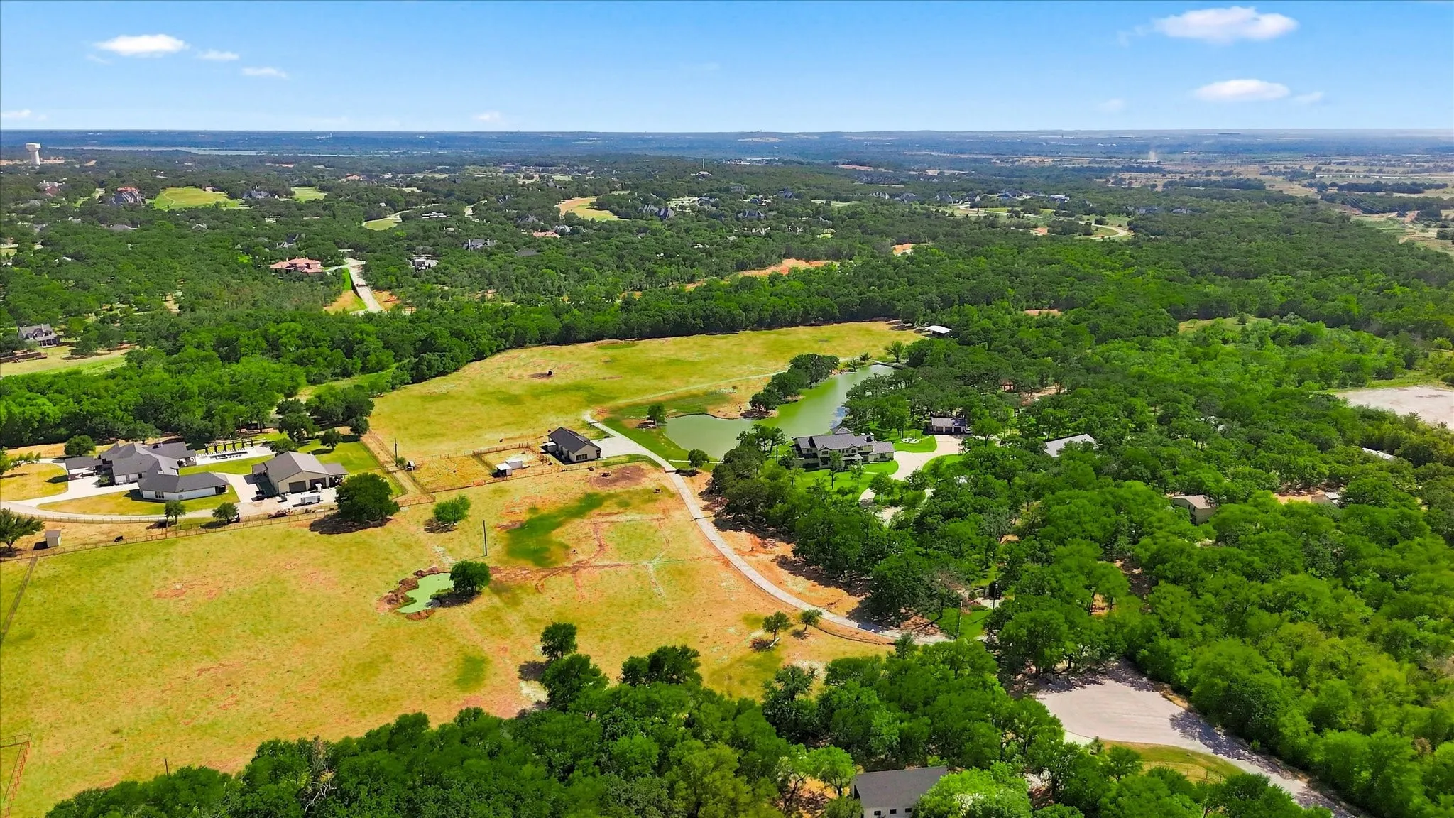Over 31 acres featuring a large body of water, several smaller ponds, and a variety of mature trees and open fields