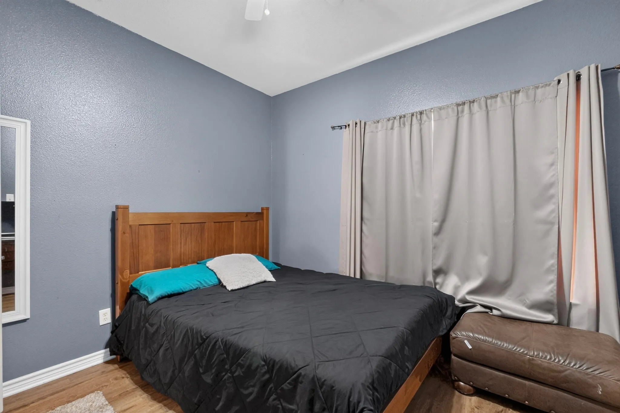 Wood-finish flooring, light blue wall paint, and white trim