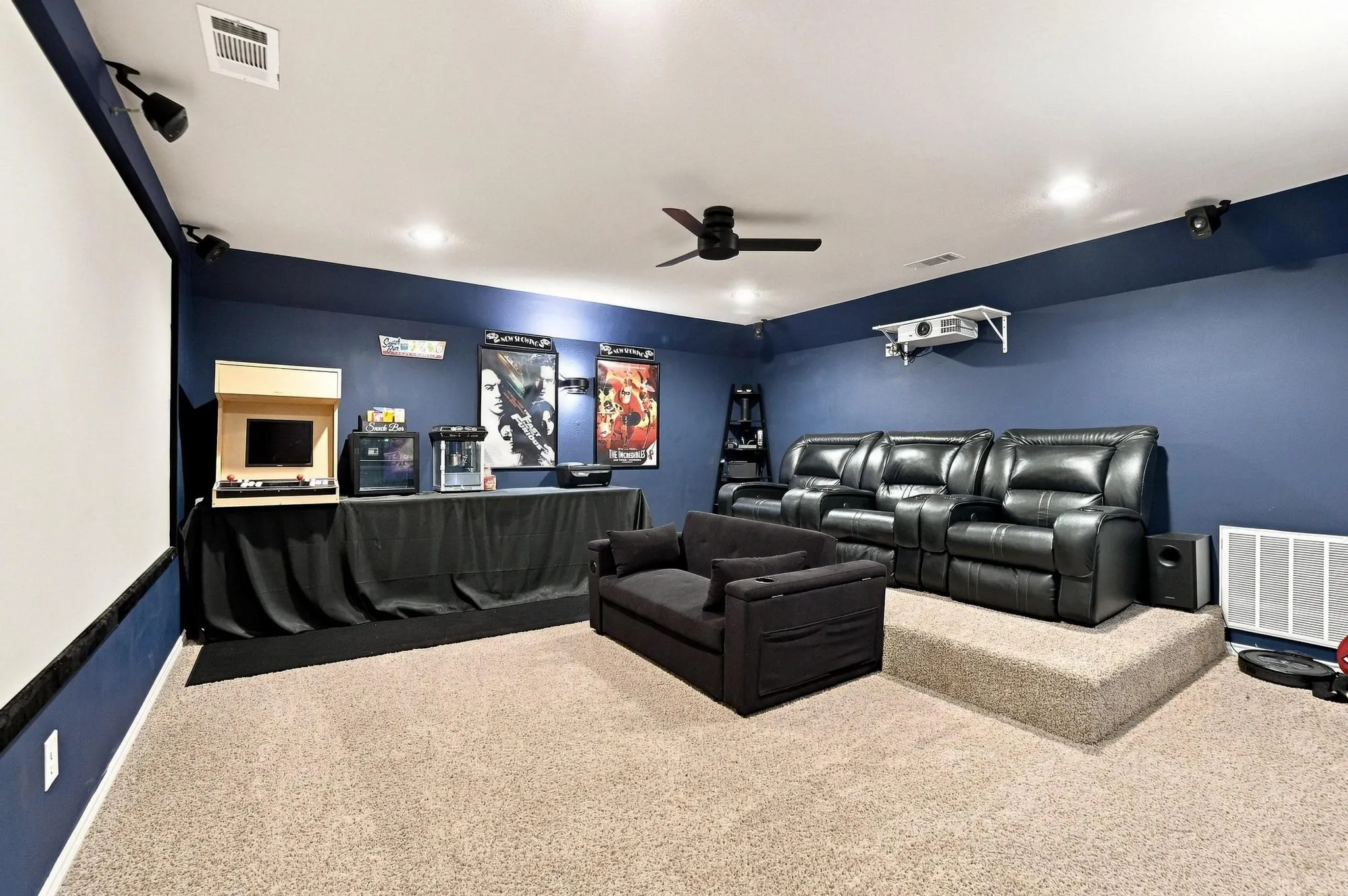 Projector screen with recessed lighting, ceiling fan, and carpeted flooring